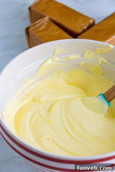 Arranging fresh, thinly sliced bananas meticulously over the creamy pudding layer, ensuring every bite will have that natural fruit sweetness.