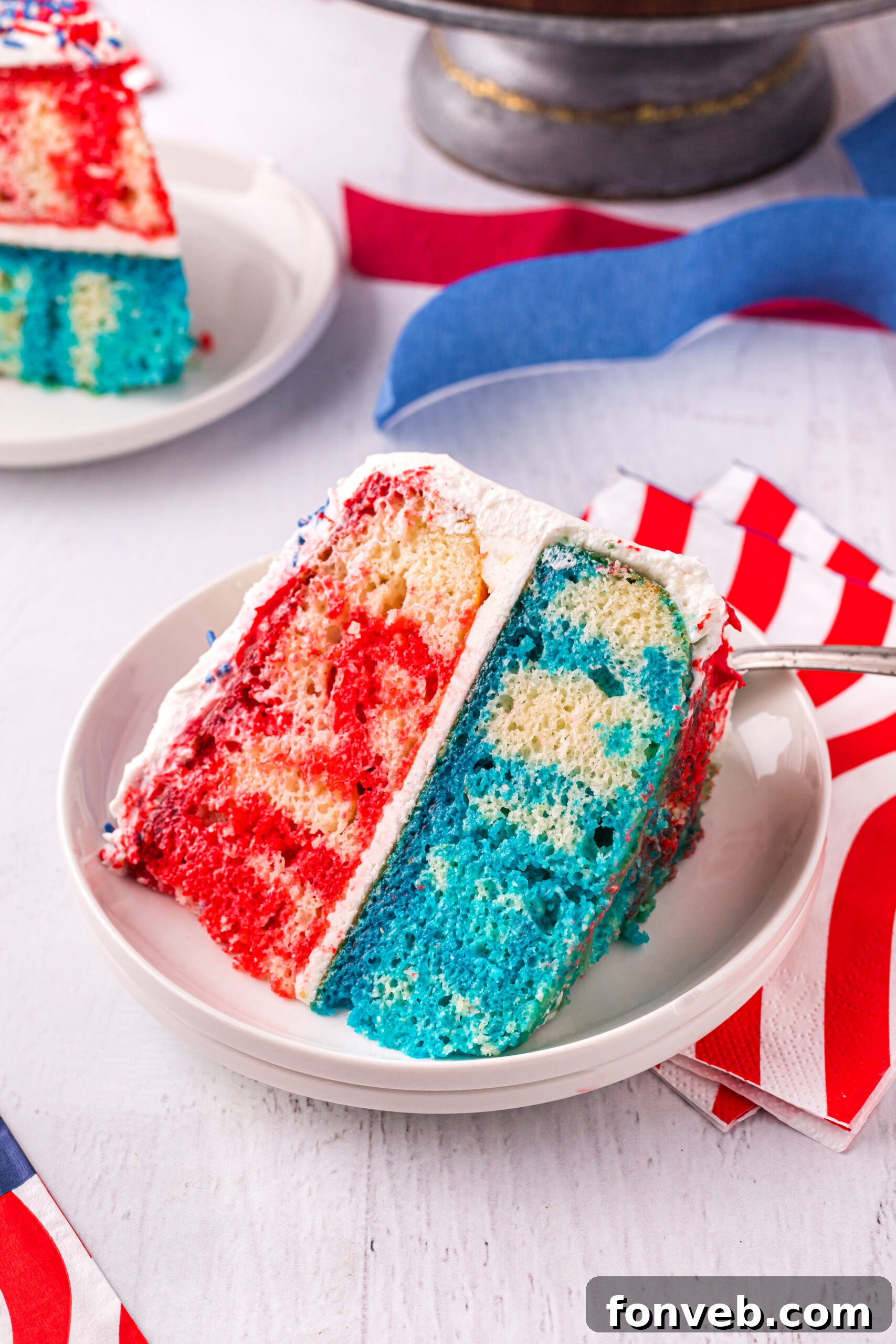 Front view of a slice of 4th of July Cake on a white plate, showcasing its festive and delicious layers.