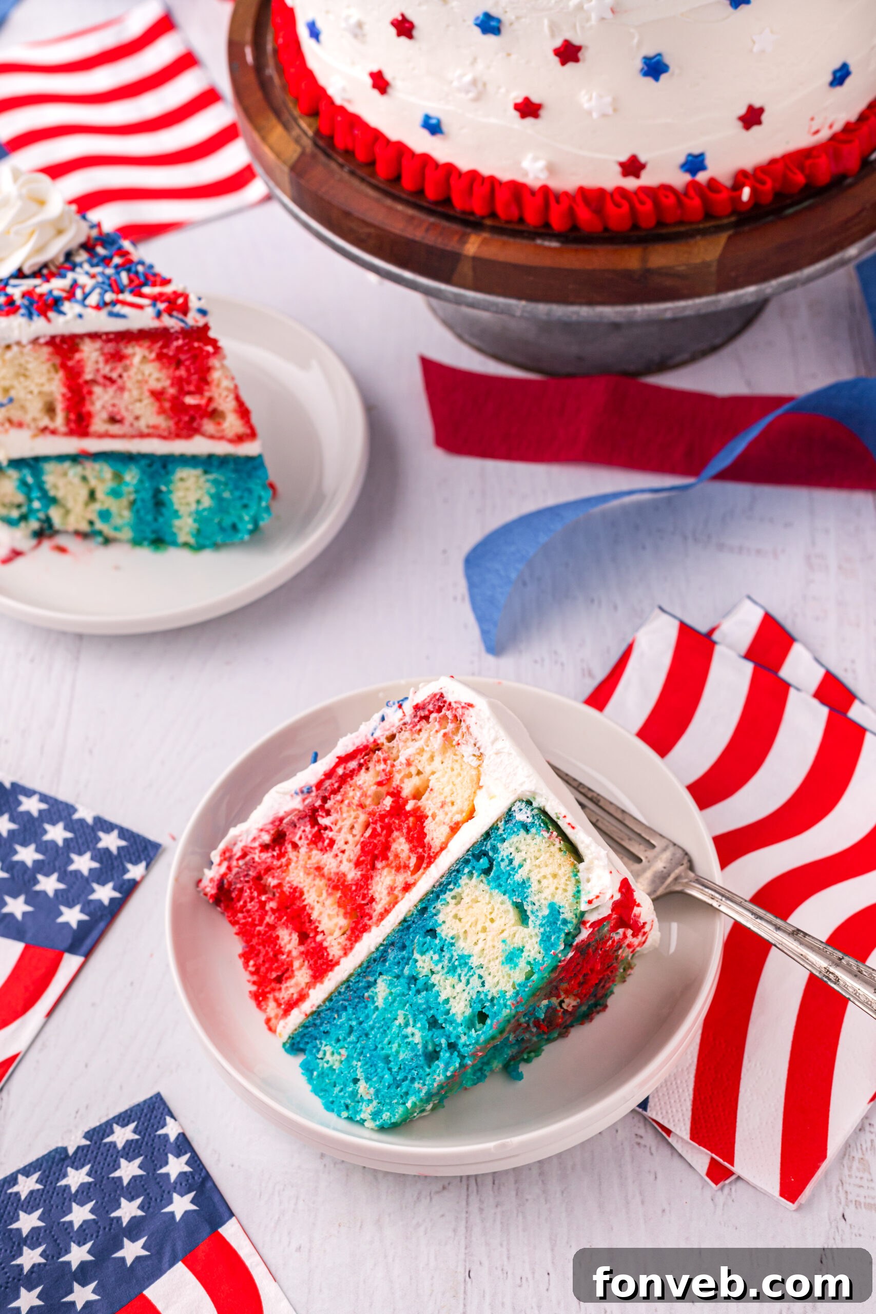 Overhead view of a slice of 4th of July Cake on a white plate, showing the patriotic layers from above.