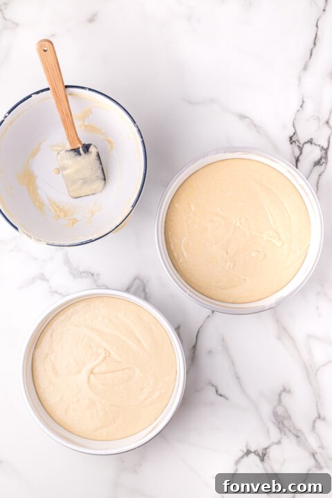 Freshly baked cake cooling on a wire rack after being removed from the oven.
