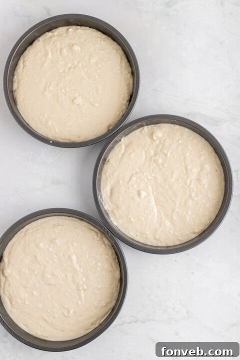 Tropical Coconut Dream Cake 13 Creamy coconut cream cheese frosting being prepared in a stand mixer.