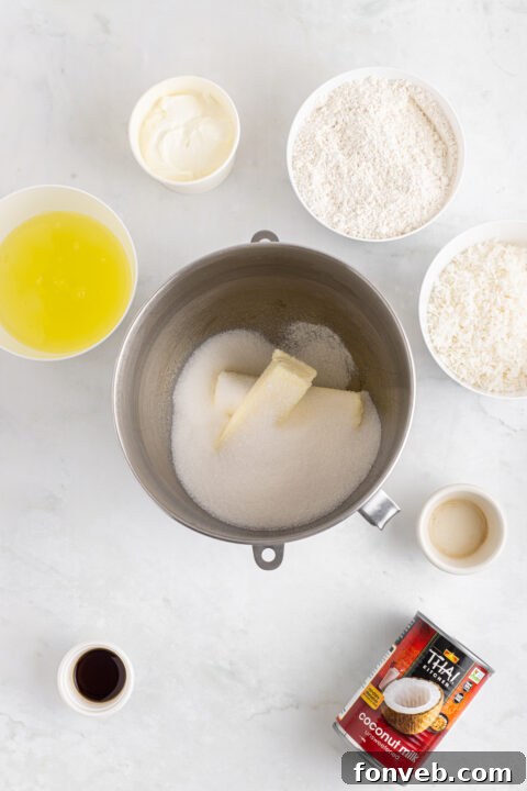 Tropical Coconut Dream Cake 10 Close-up of fluffy cake batter being mixed in a stand mixer.
