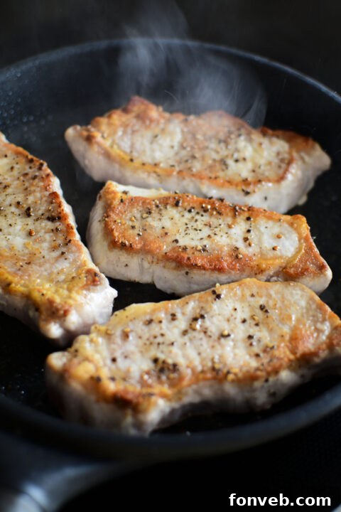 Step-by-step image of pork chops searing in a skillet.
