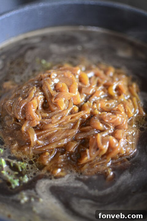 Step-by-step image of mustard being spread on pork chops.