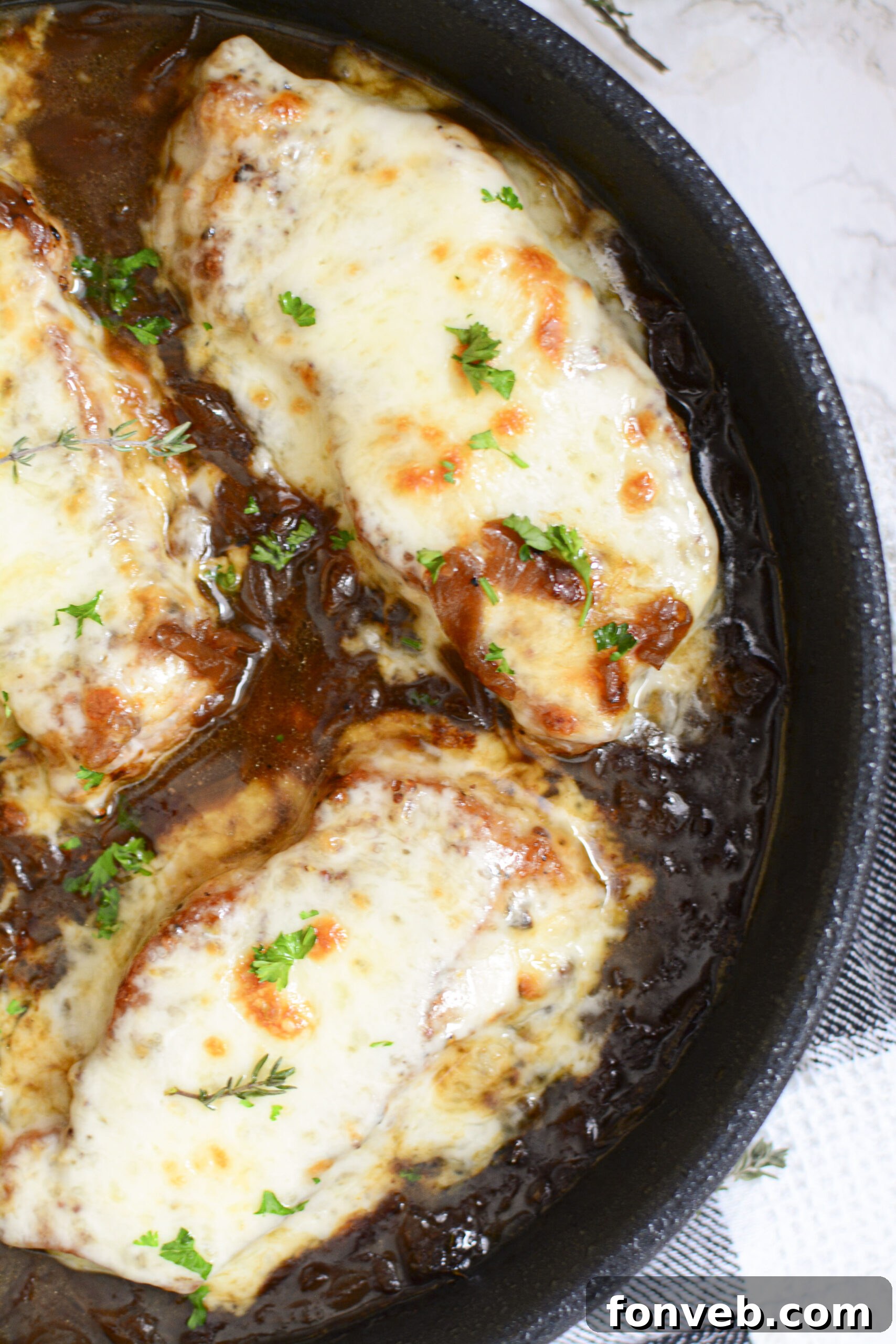 Overhead shot of French Onion Pork Chops in a cast iron skillet, presenting a full view of the dish ready to be served.