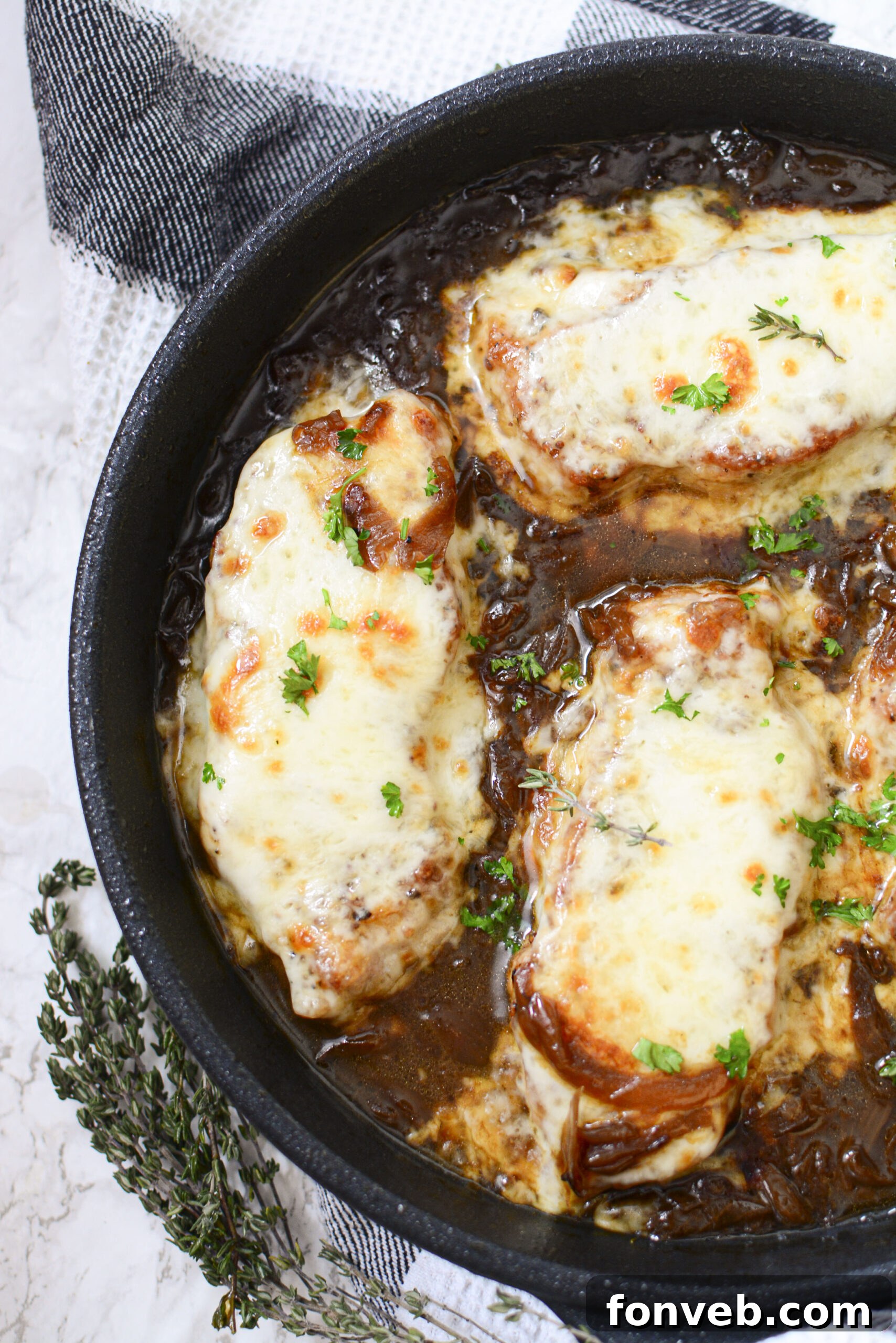 Top-down view of French Onion Pork Chops, emphasizing the savory gravy and perfectly cooked pork.