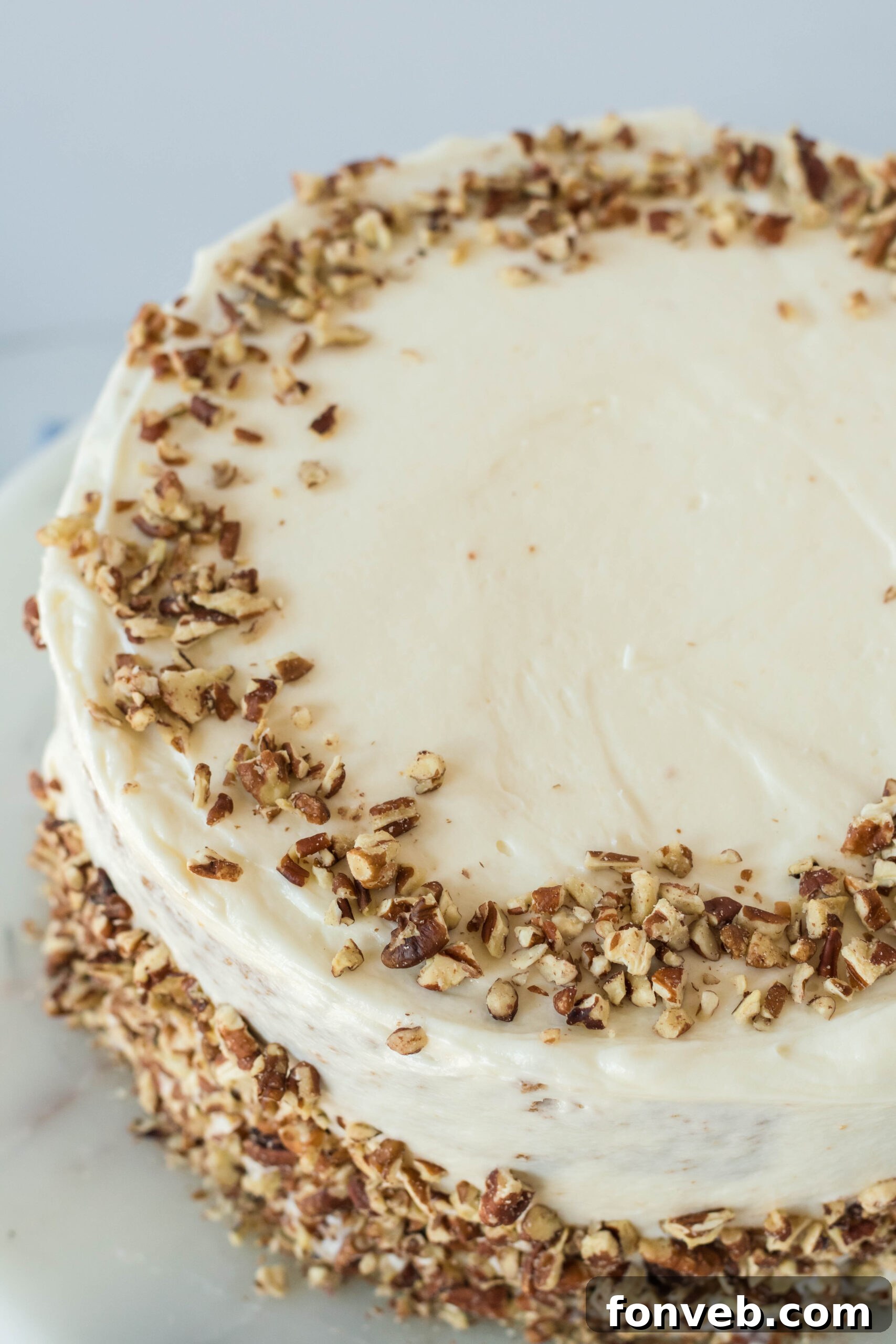 Close up view of Carrot Cake Cheesecake on a marble cake stand.