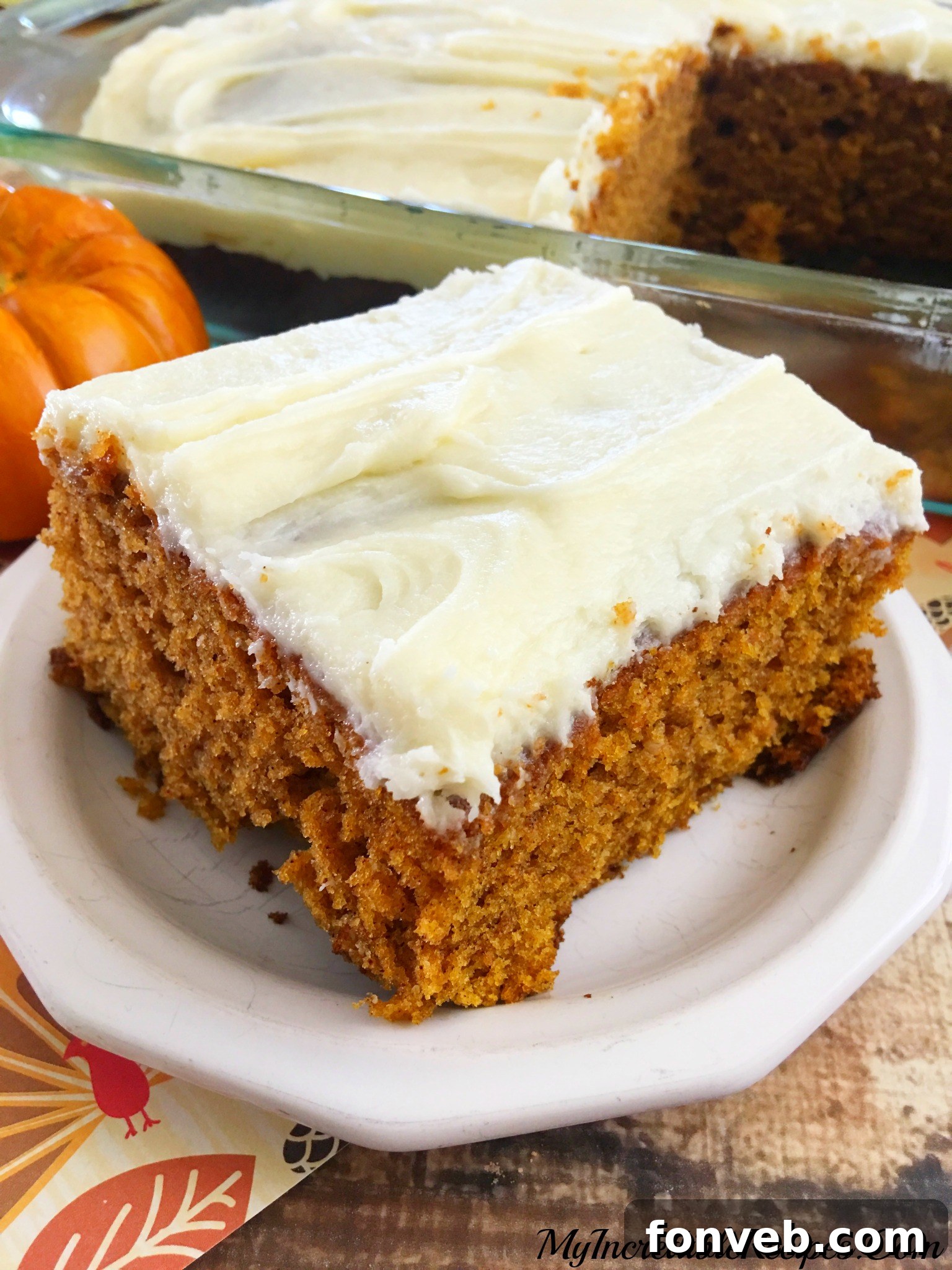 Luscious Pumpkin Spice Cake with Velvety Cream Cheese Frosting 7 Several squares of pumpkin cake with frosting, arranged enticingly