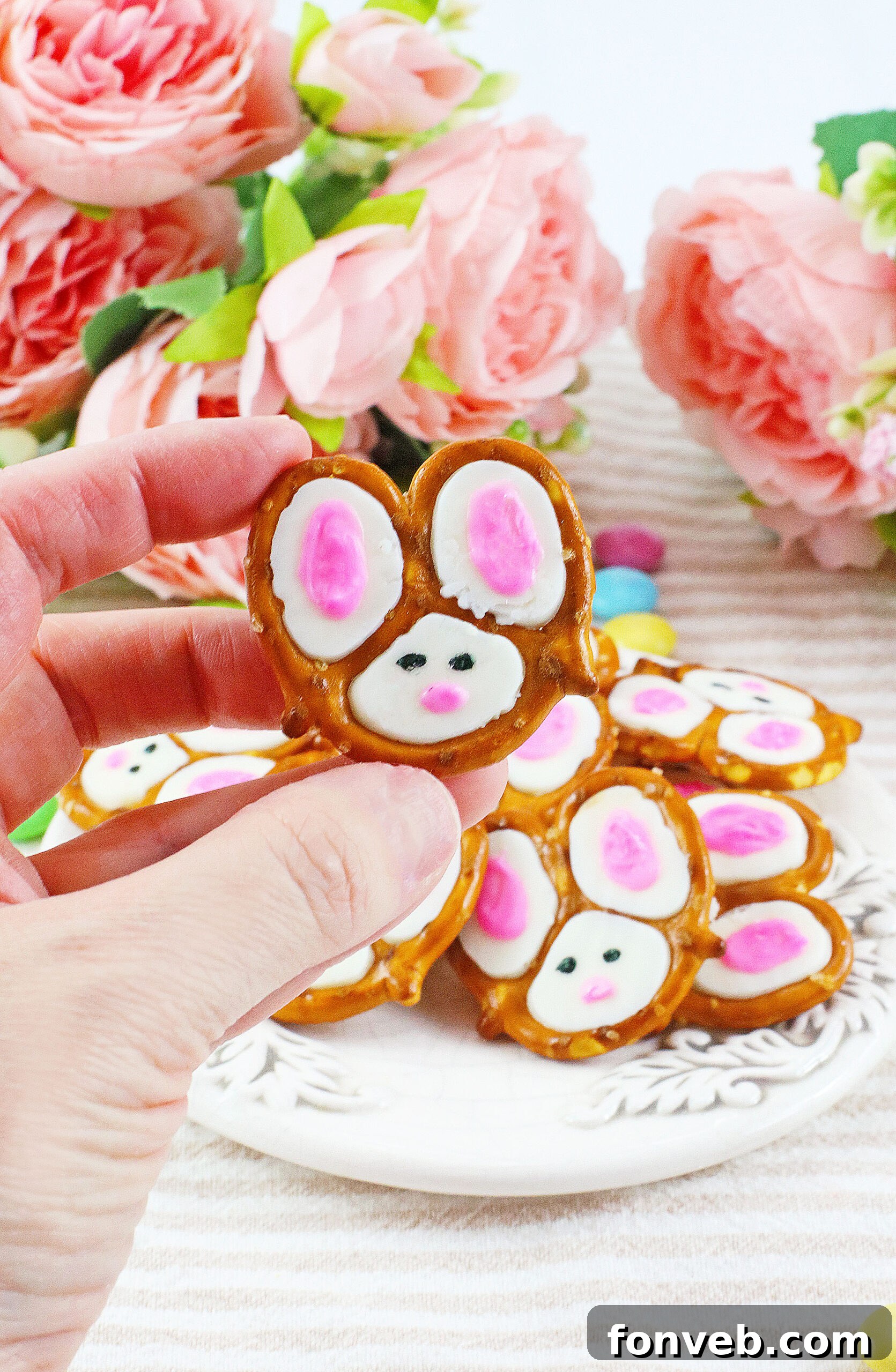 Hoppy Twists 12 A close-up of a single Bunny Pretzel being held delicately, showcasing its intricate details and tempting appeal.