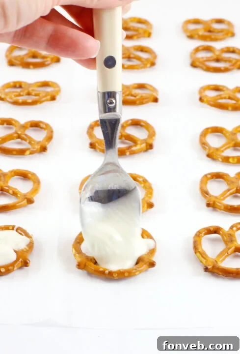 Hoppy Twists 5 A step-by-step image showing the application of pink chocolate to form the bunny's ears on a white-dipped pretzel.