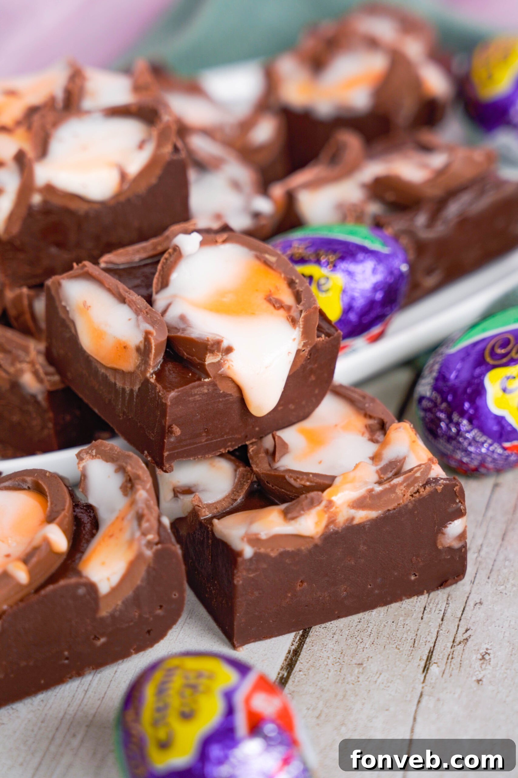 Front view of Cadbury Cream Fudge stacked on a white dish.