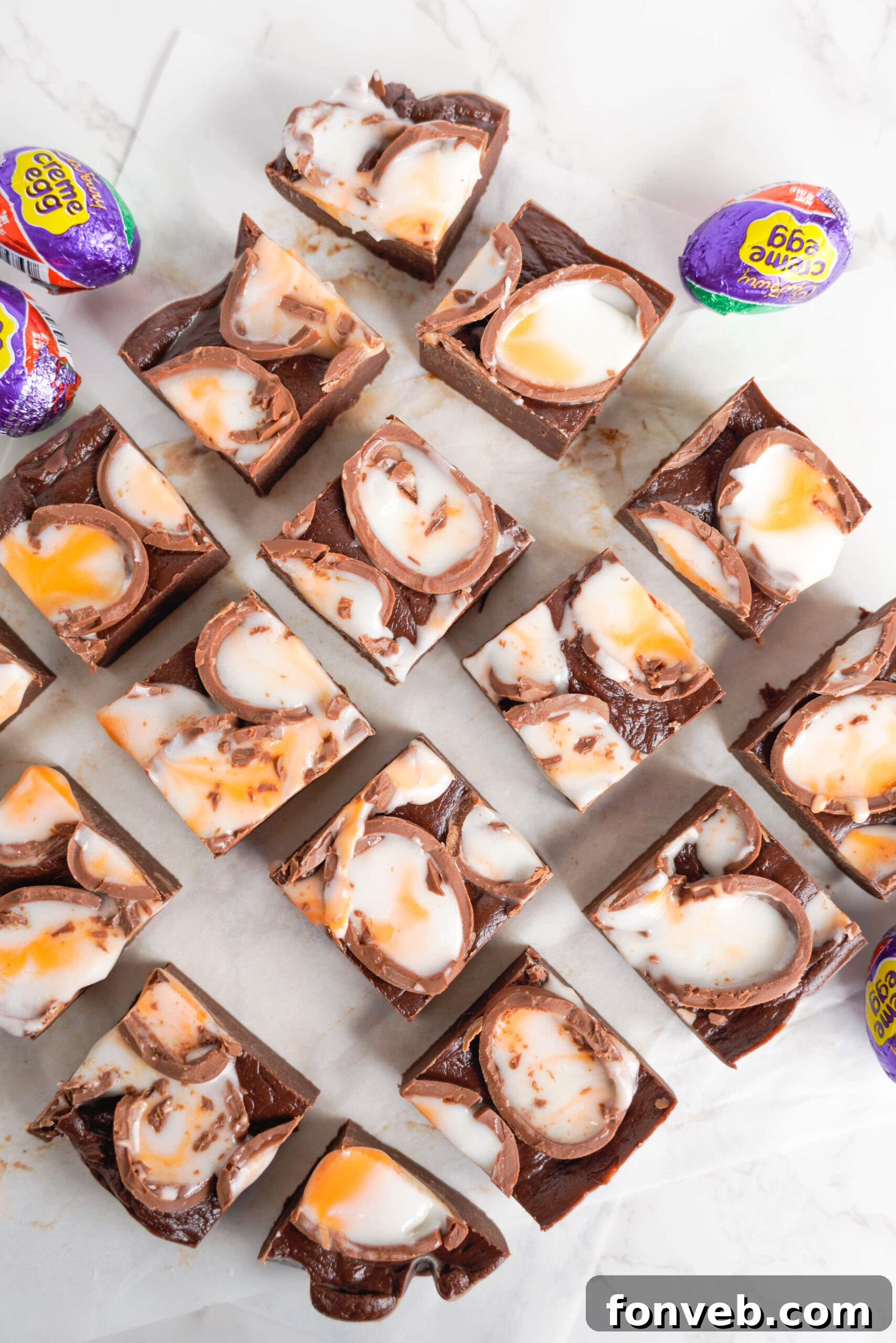 Overhead view of Cadbury Cream Fudge on a piece of parchment paper.