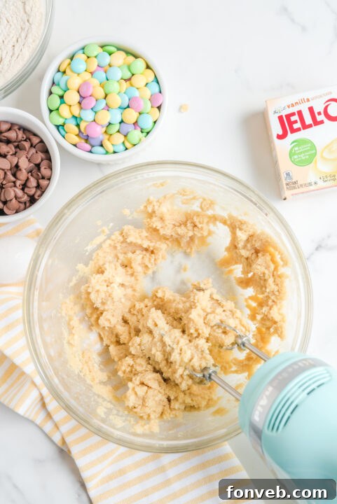 Scooped cookie dough balls ready for baking on a parchment-lined tray.