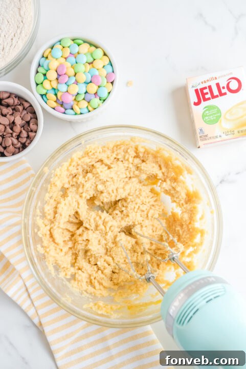 Freshly baked Easter Pudding Cookies cooling on a baking sheet.