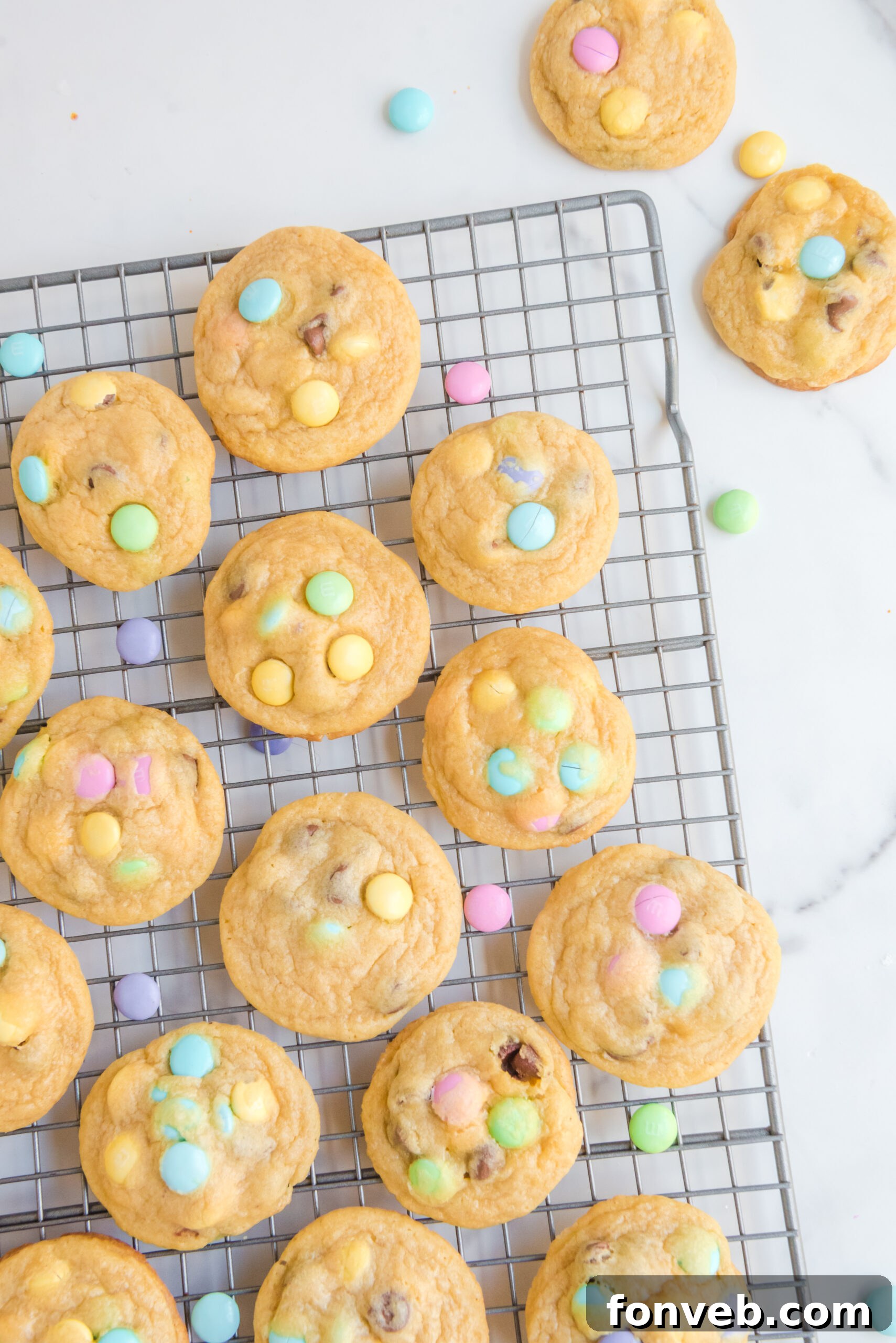 Overhead view of freshly baked Easter Pudding Cookies cooling on a wire rack.