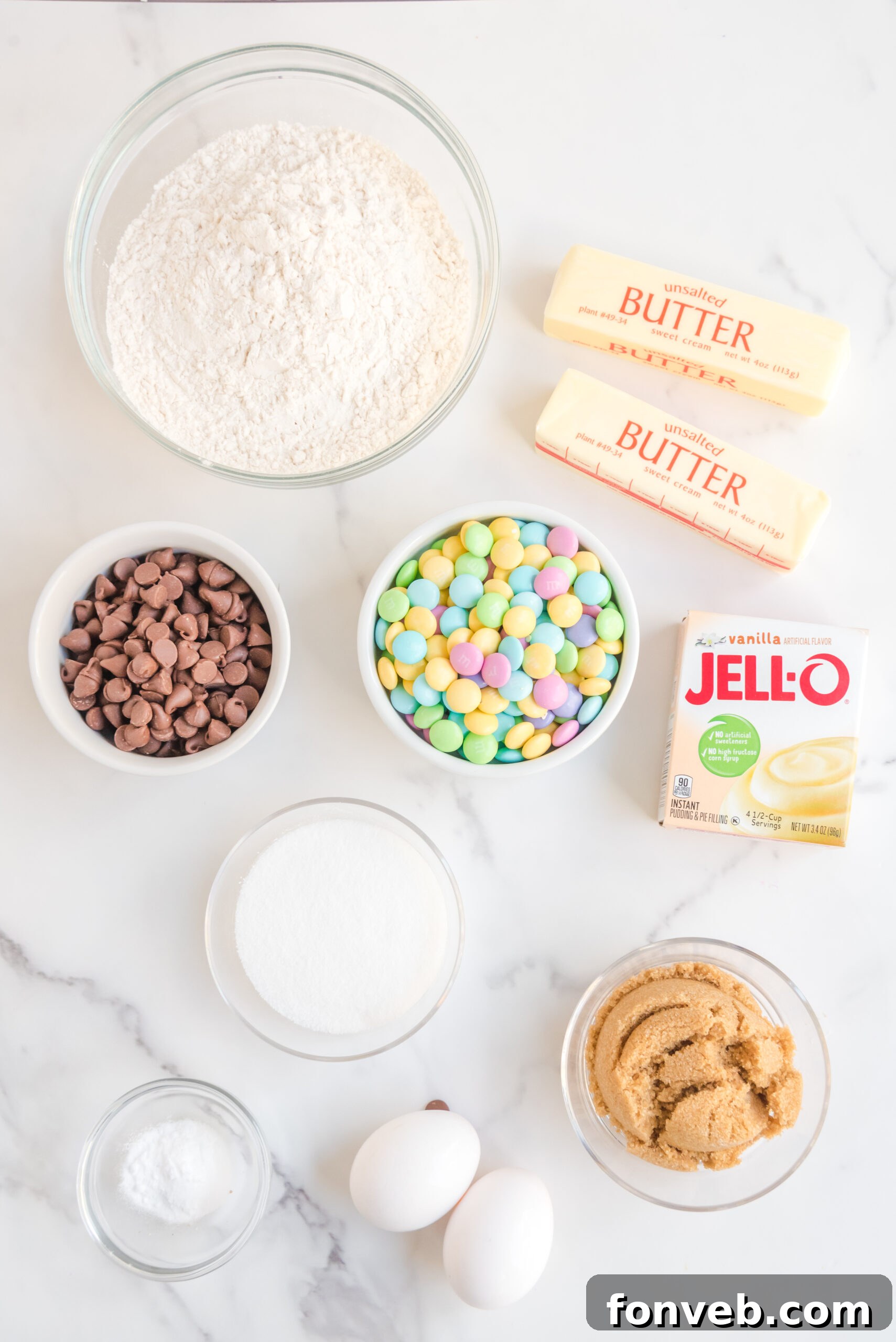 Overhead view of all the measured ingredients needed for the Easter Pudding Cookies recipe laid out on a clean surface.