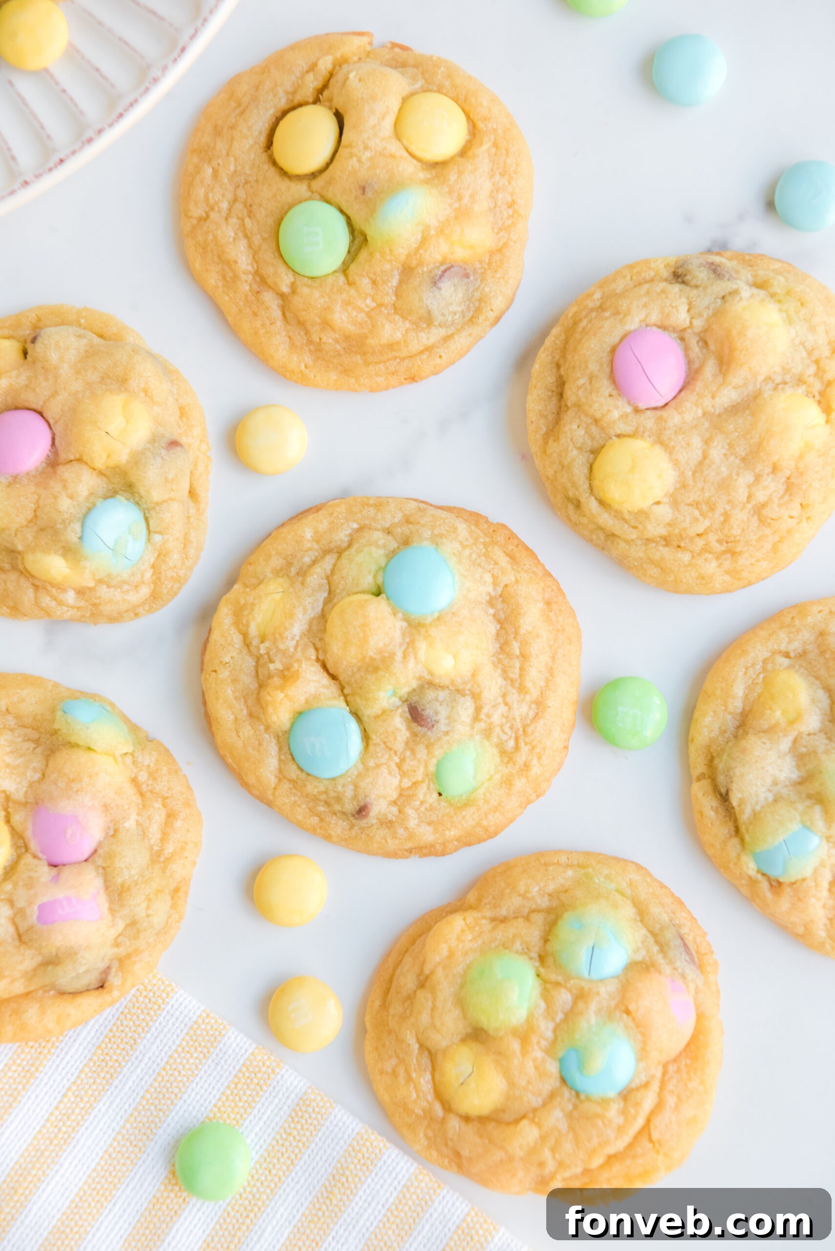 Overhead view of a tray of colorful Easter Pudding Cookies, featuring pastel M&Ms.