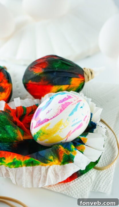 A finished tie-dye Easter egg on a paper towel.