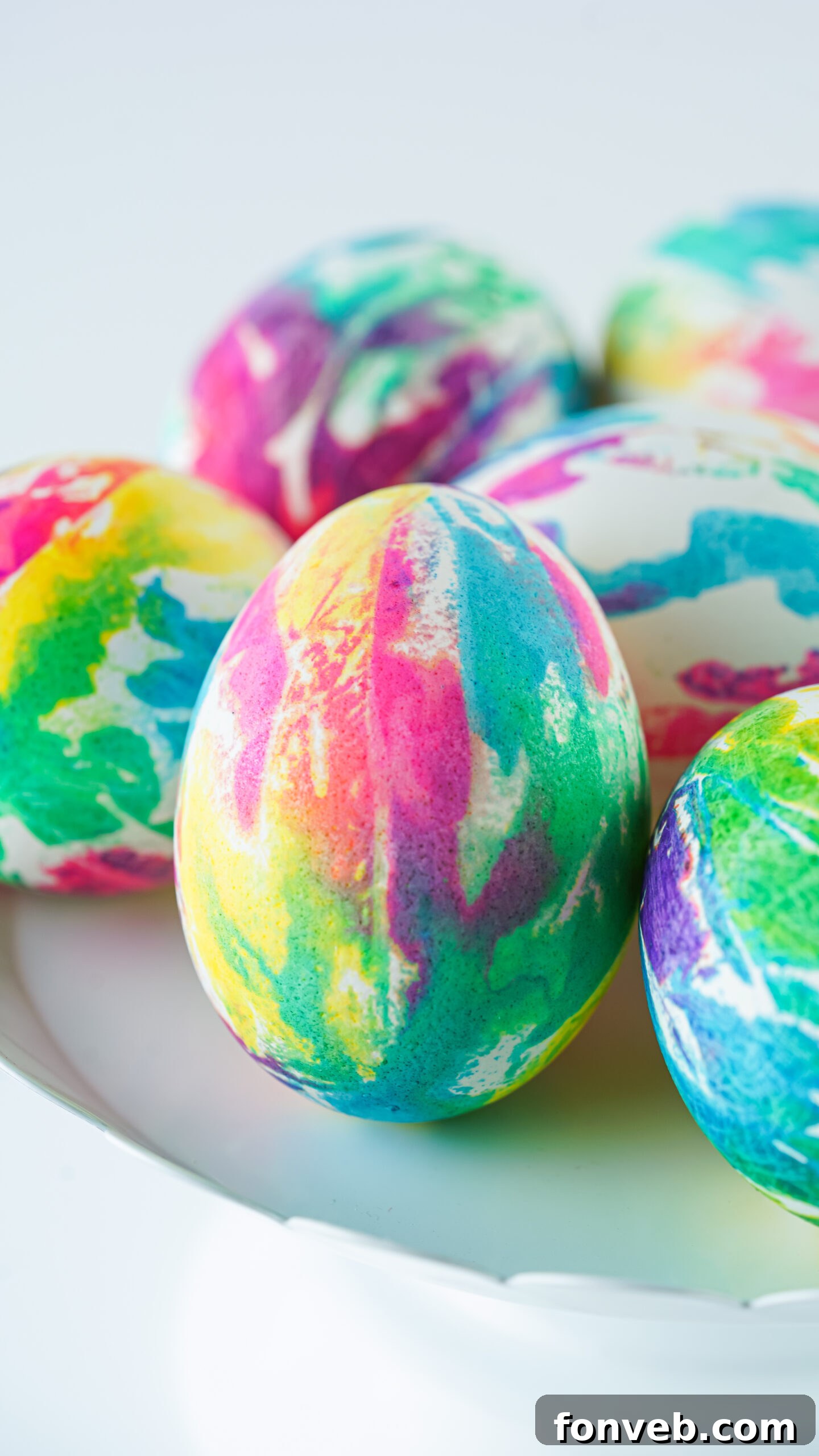 Close up view of Tie Dye Easter Eggs on a white stand.