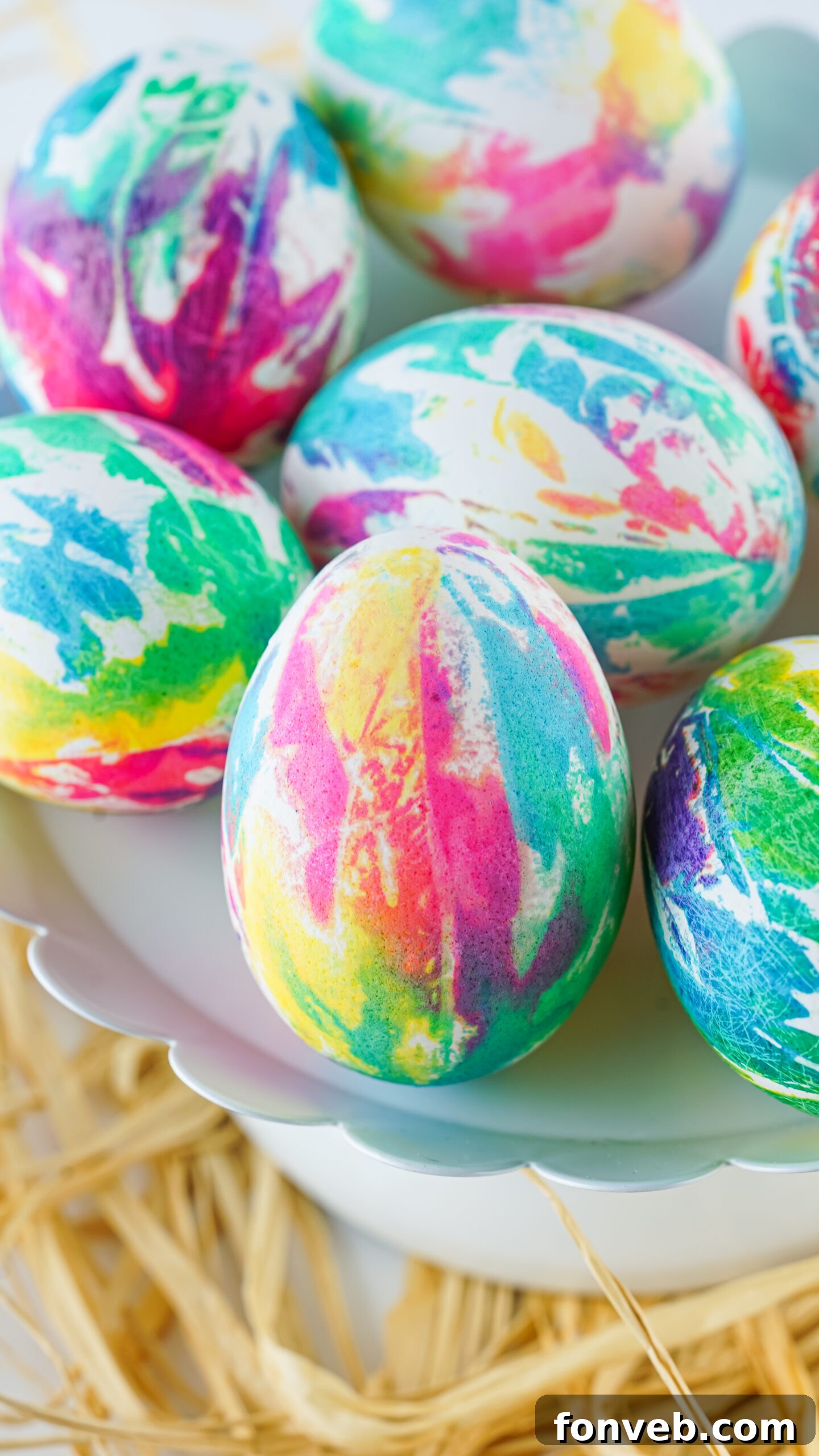 Close up view of Tie Dye Easter Eggs on a white stand.