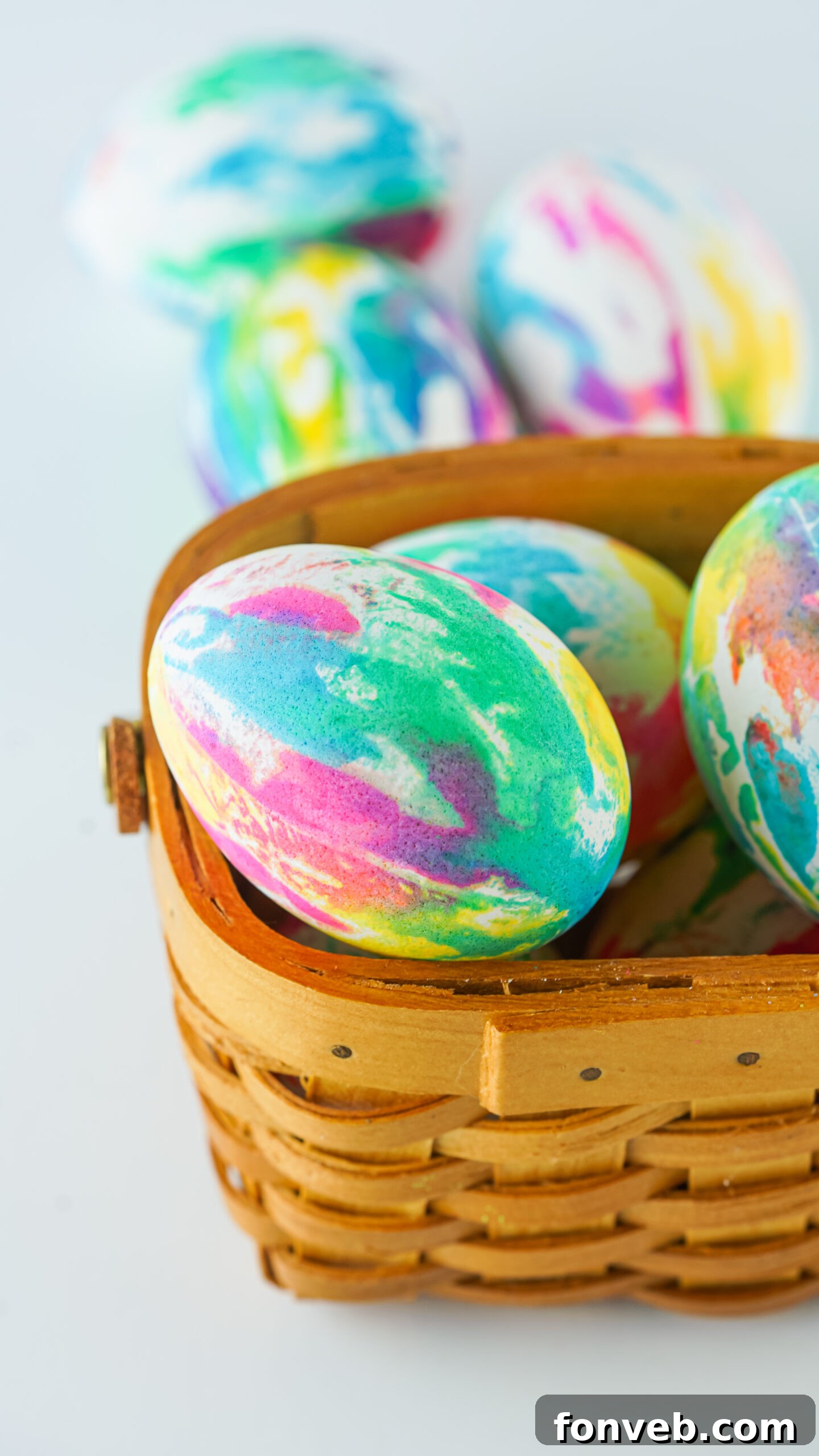 Close up view of Tie Dye Easter Eggs in a brown basket.