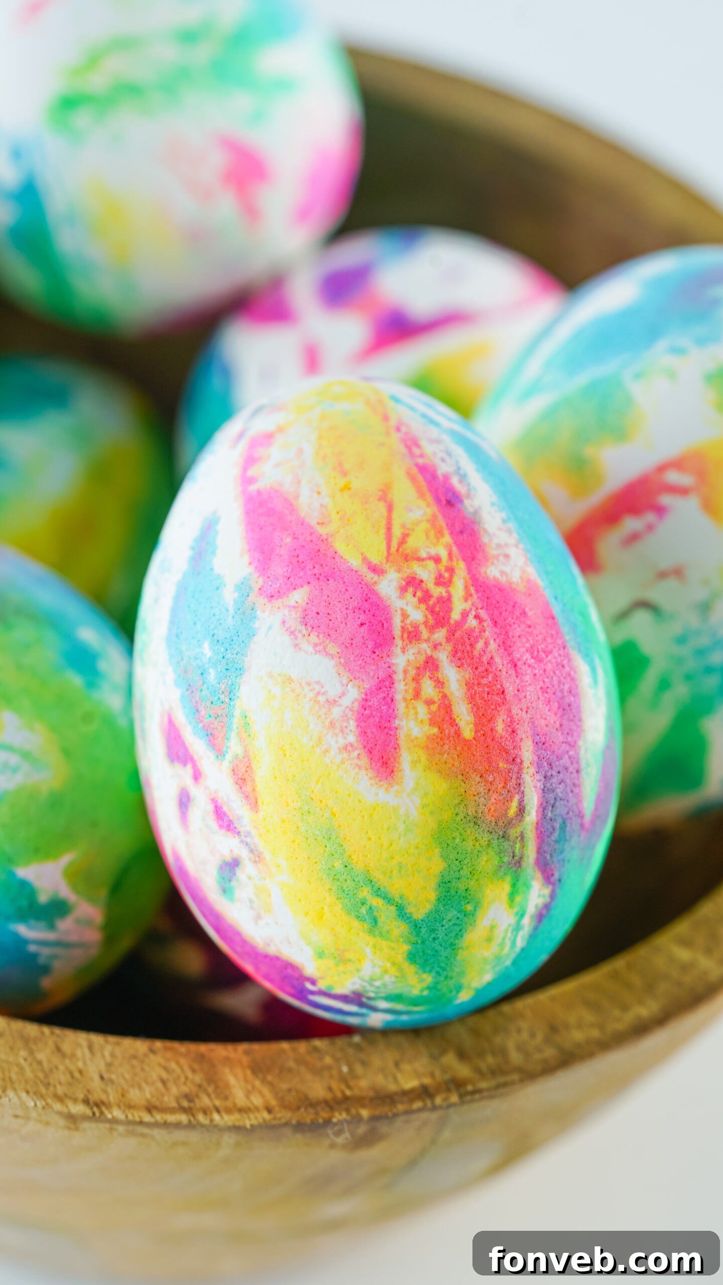 Close up view of Tie Dye Easter Eggs in a brown bowl.