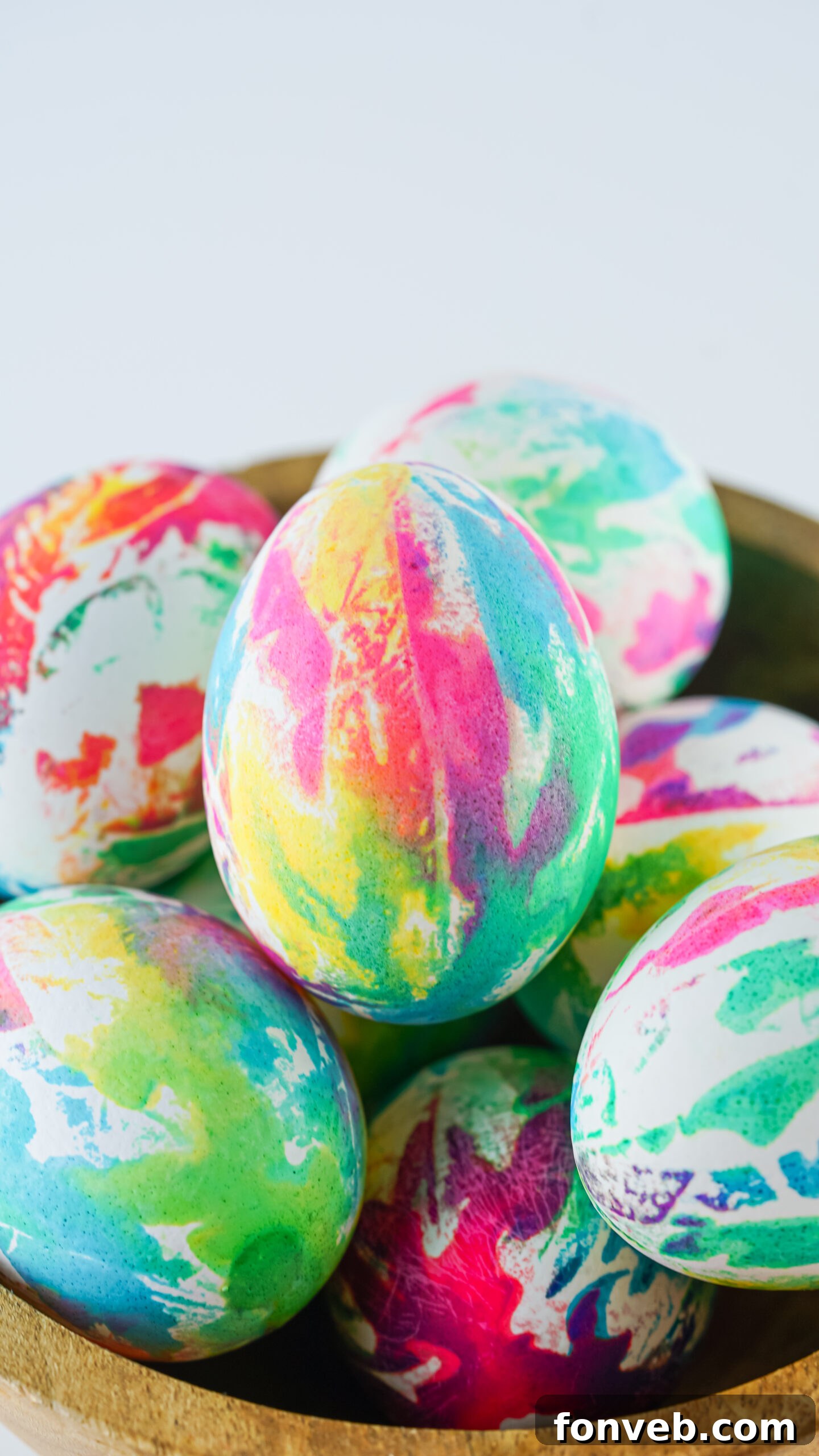 Close up view of Tie Dye Easter Eggs in a brown bowl.