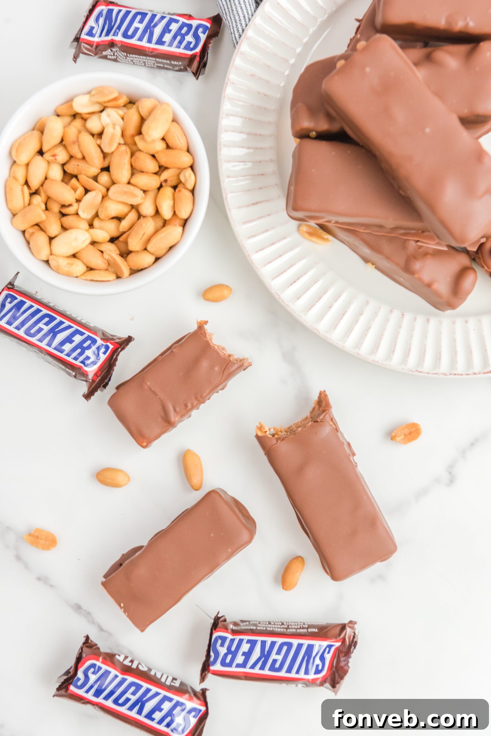 Overhead view of several Homemade Snickers Bars with bites removed from two bars, showcasing their irresistible appeal.