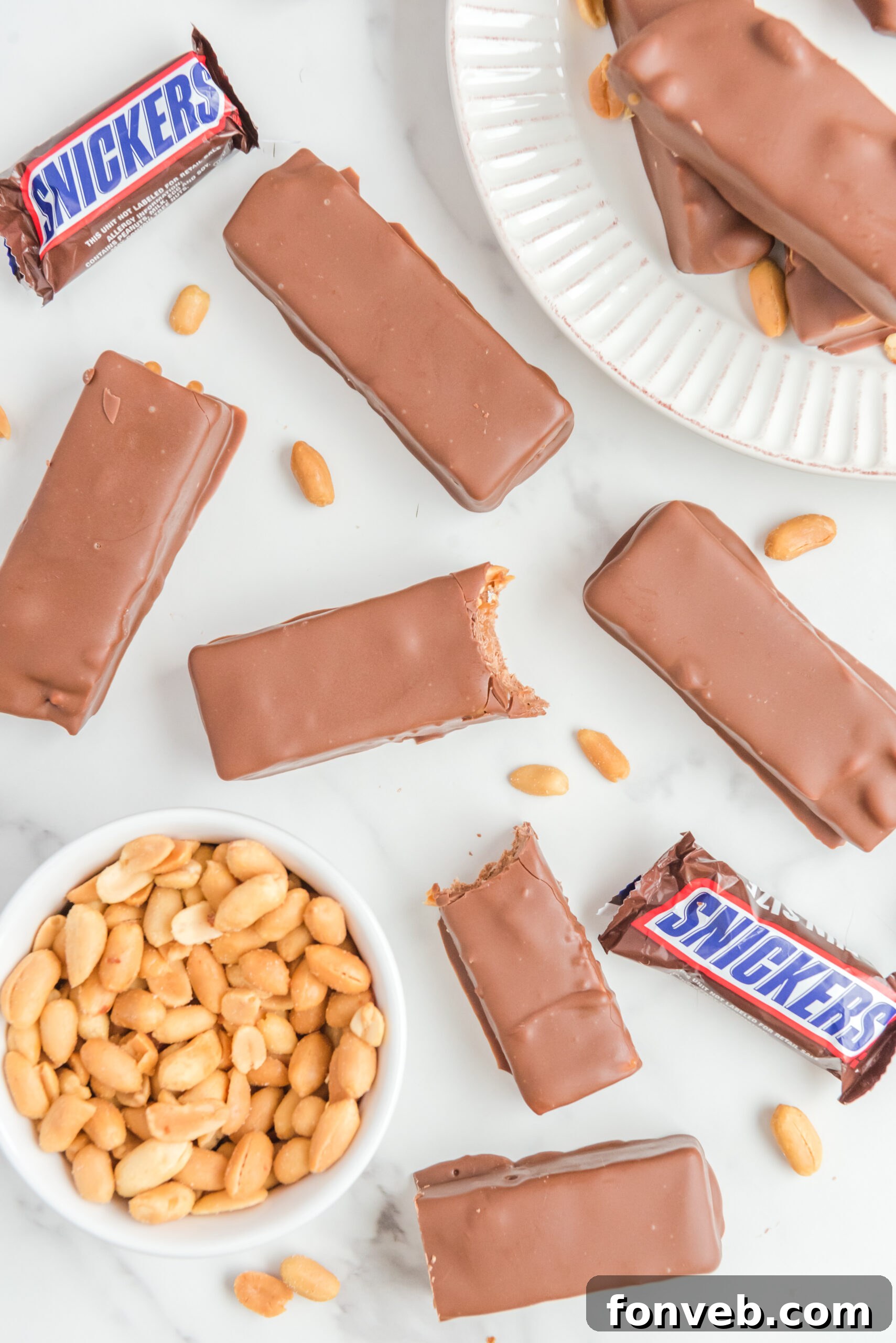 Overhead view of Homemade Snickers Bars with bites removed from two bars, highlighting their delicious composition.