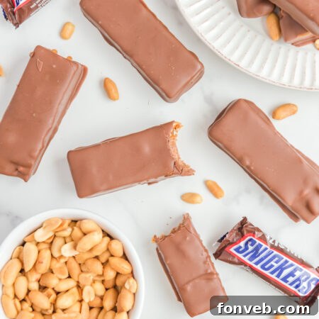 A delicious homemade Snickers bar, cut in half to show the layered interior.