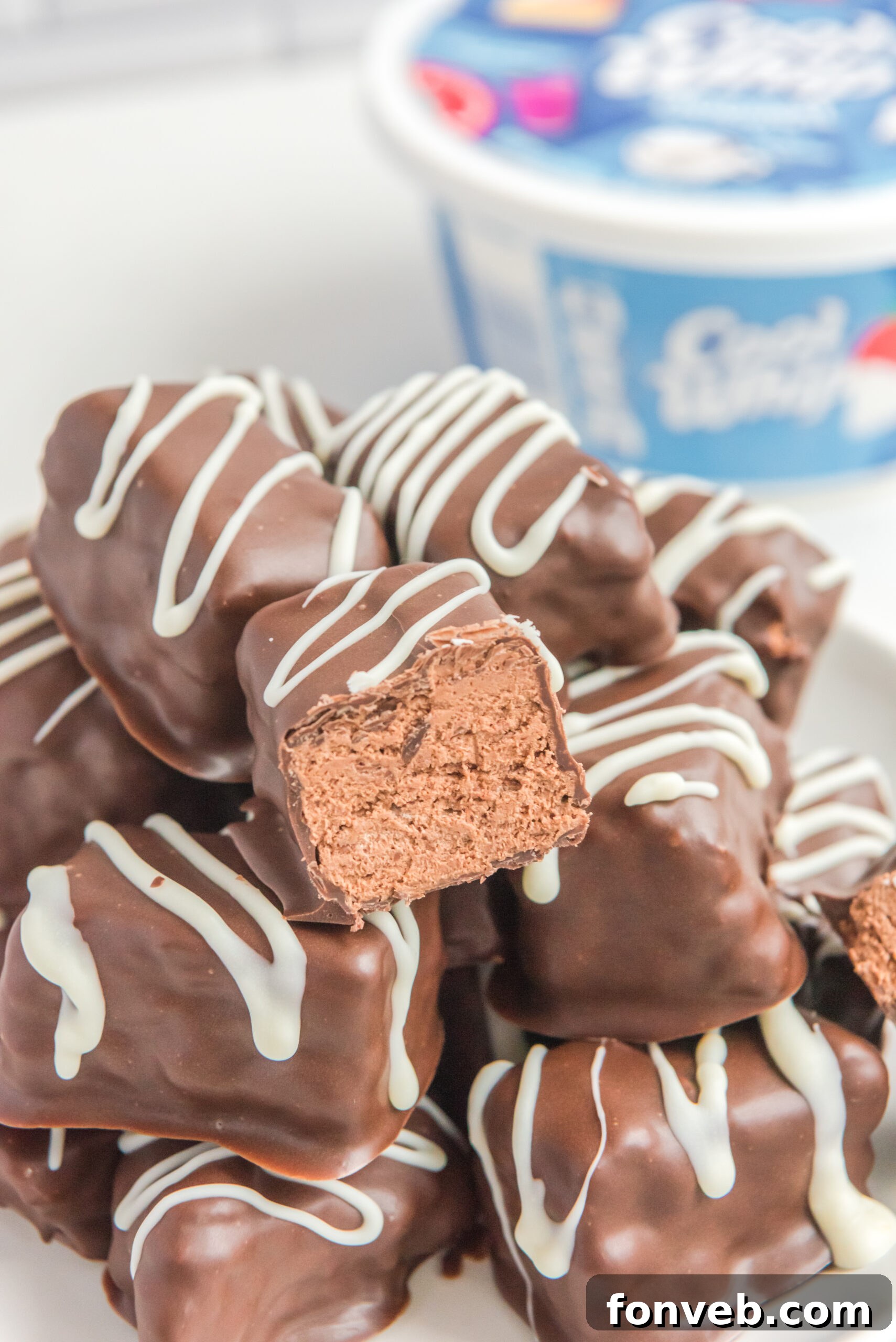 Sweet Cloud Candies 2 A generous stack of homemade Cool Whip Candy bars, with one bar showing a delicious bite taken out, revealing its creamy interior.