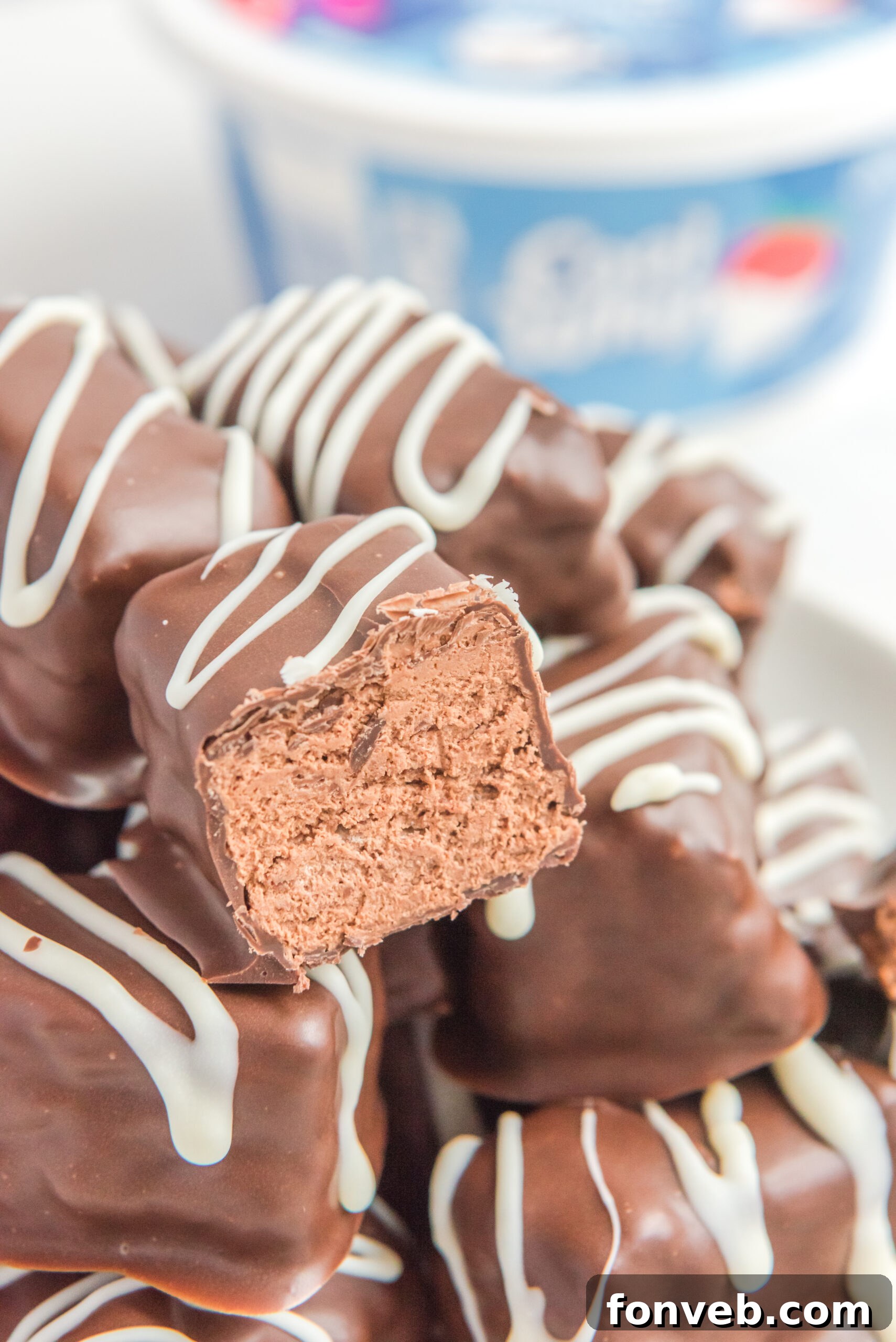 Sweet Cloud Candies 11 A close-up view of a half-cut Cool Whip Candy bar resting on a stack of whole candy bars, ready to be enjoyed.