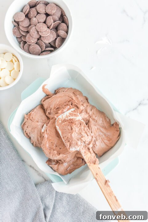 Sweet Cloud Candies 13 Cool Whip Candy mixture being smoothed into a pan, demonstrating a key step in preparation.