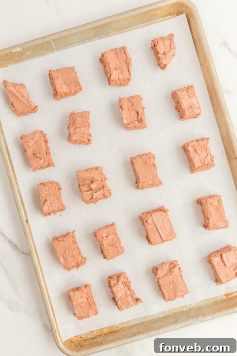 Sweet Cloud Candies 14 Individual Cool Whip Candy bars being coated in melted chocolate, showcasing the dipping process.