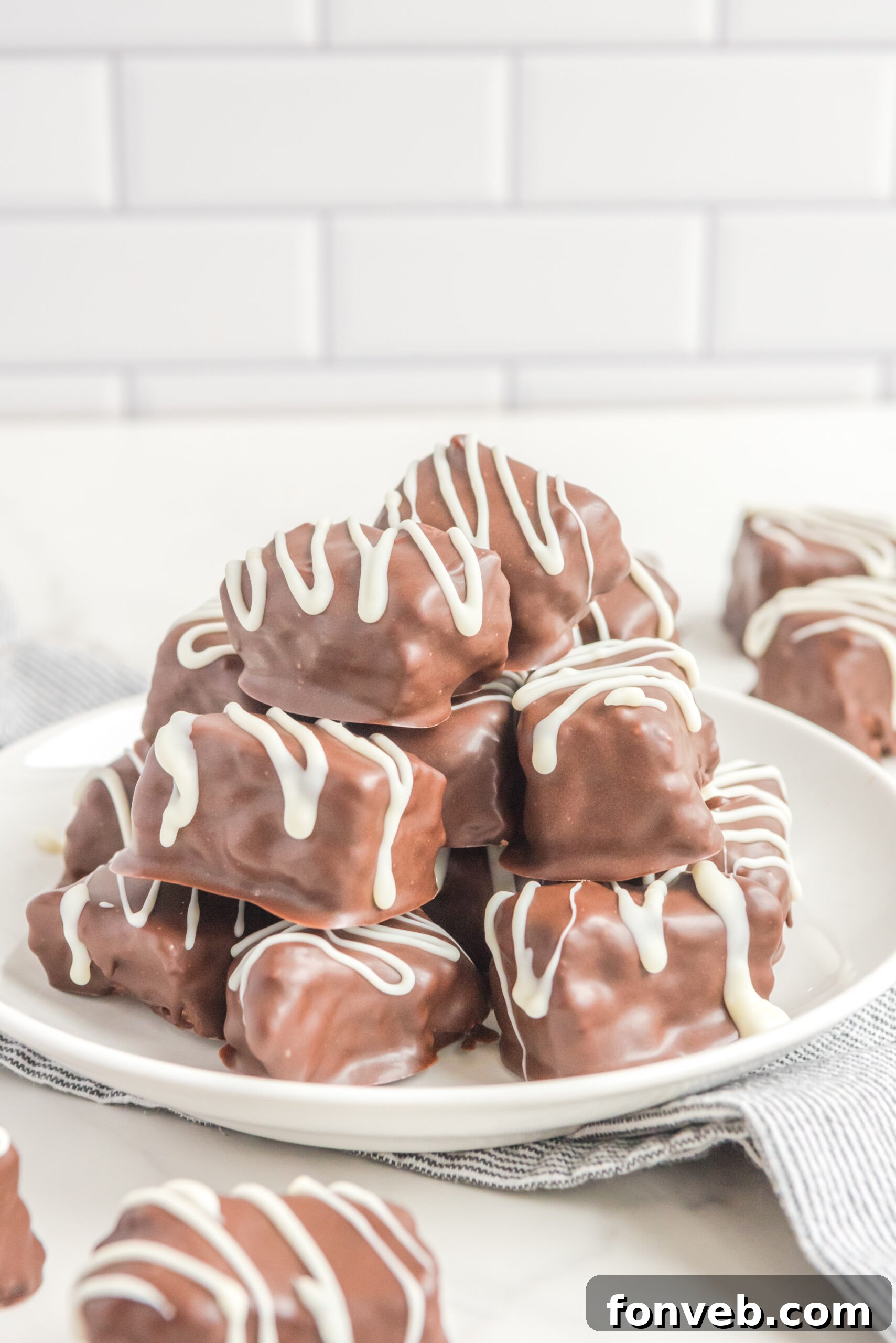 Sweet Cloud Candies 4 A close-up, front view of another enticing stack of Cool Whip Candy on a clean white plate, emphasizing the smooth chocolate finish.
