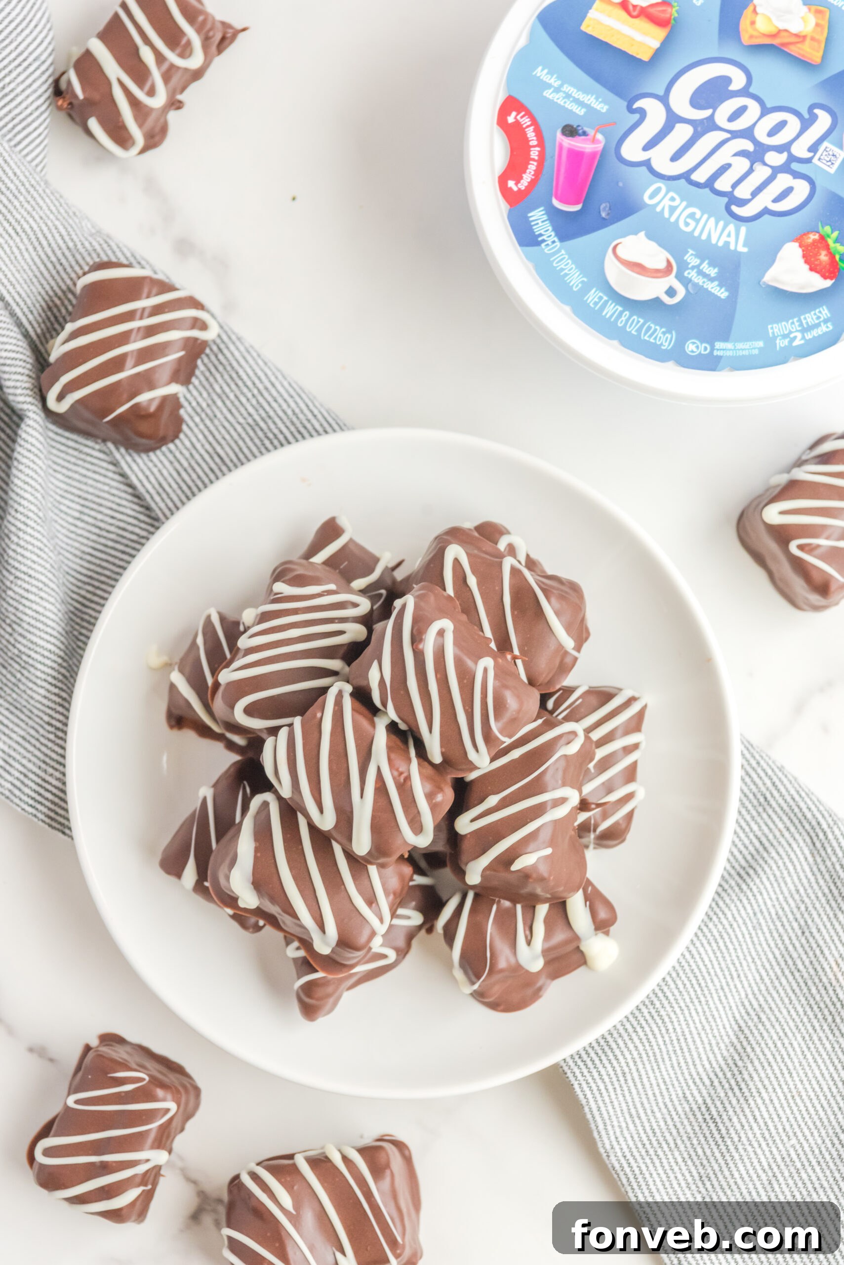 Sweet Cloud Candies 6 Another overhead perspective of Cool Whip Candy bars neatly stacked on a white plate, highlighting their uniform size and inviting appearance.