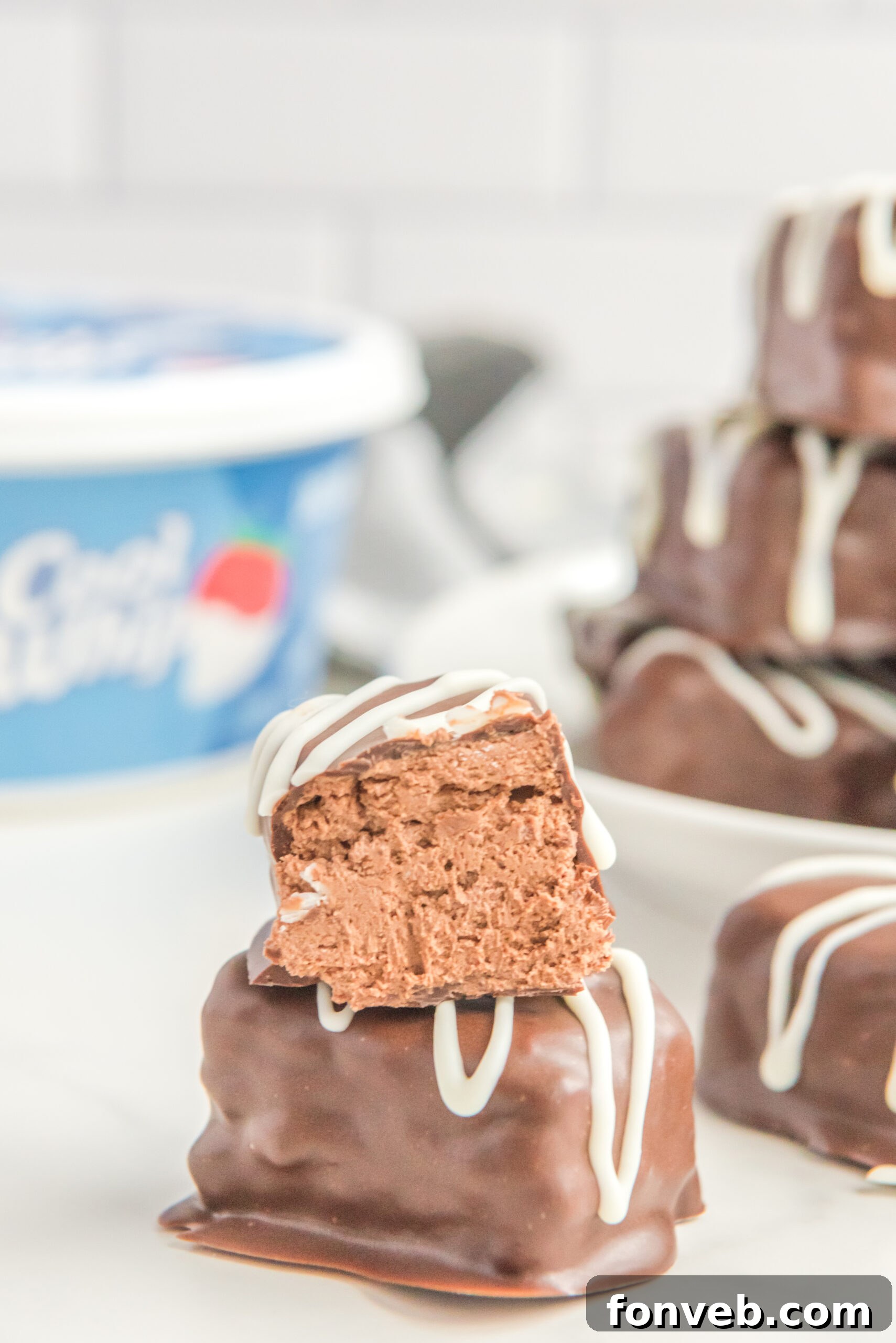 Sweet Cloud Candies 8 A creative shot of a half-eaten Cool Whip Candy bar stacked atop a full one, tempting viewers with its delicious appearance.