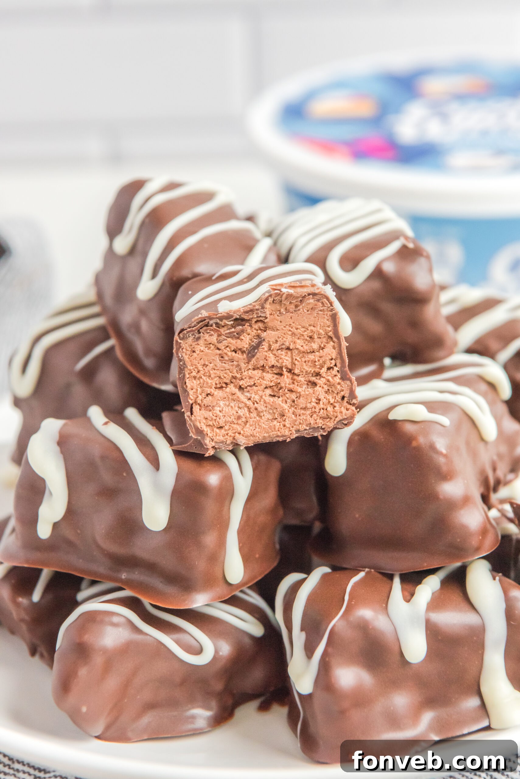 Sweet Cloud Candies 9 A close-up shot of a single Cool Whip Candy bar, with a bite taken out, resting on a stack of whole bars.