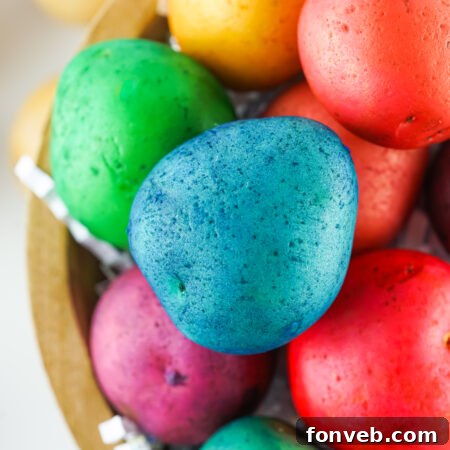 Dyed Easter Egg Potatoes in a brown bowl, used as the main image for the recipe card.
