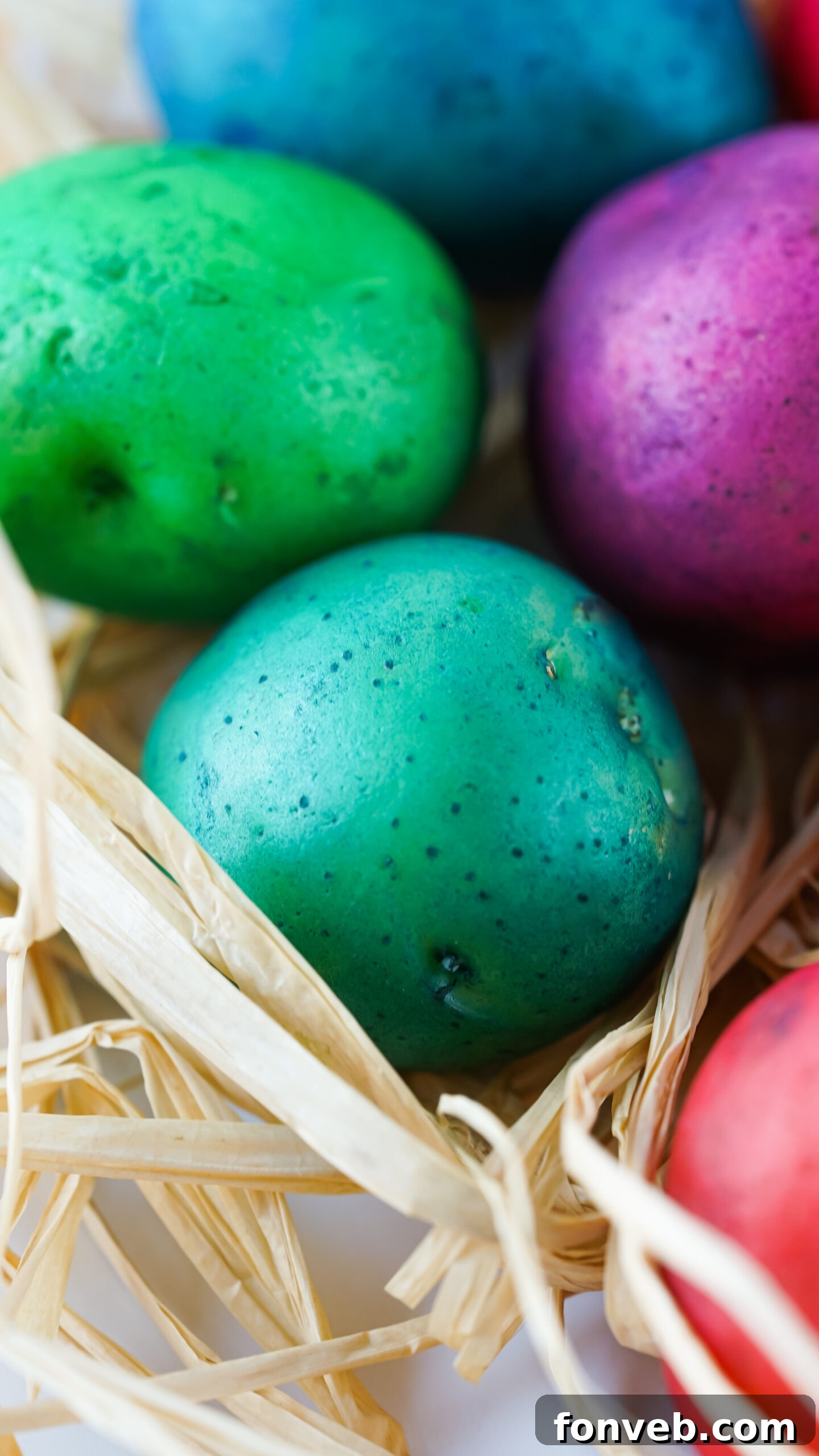 An intimate close-up shot of several individual Dyed Easter Egg Potatoes, highlighting their smooth surfaces and rich, painted colors.