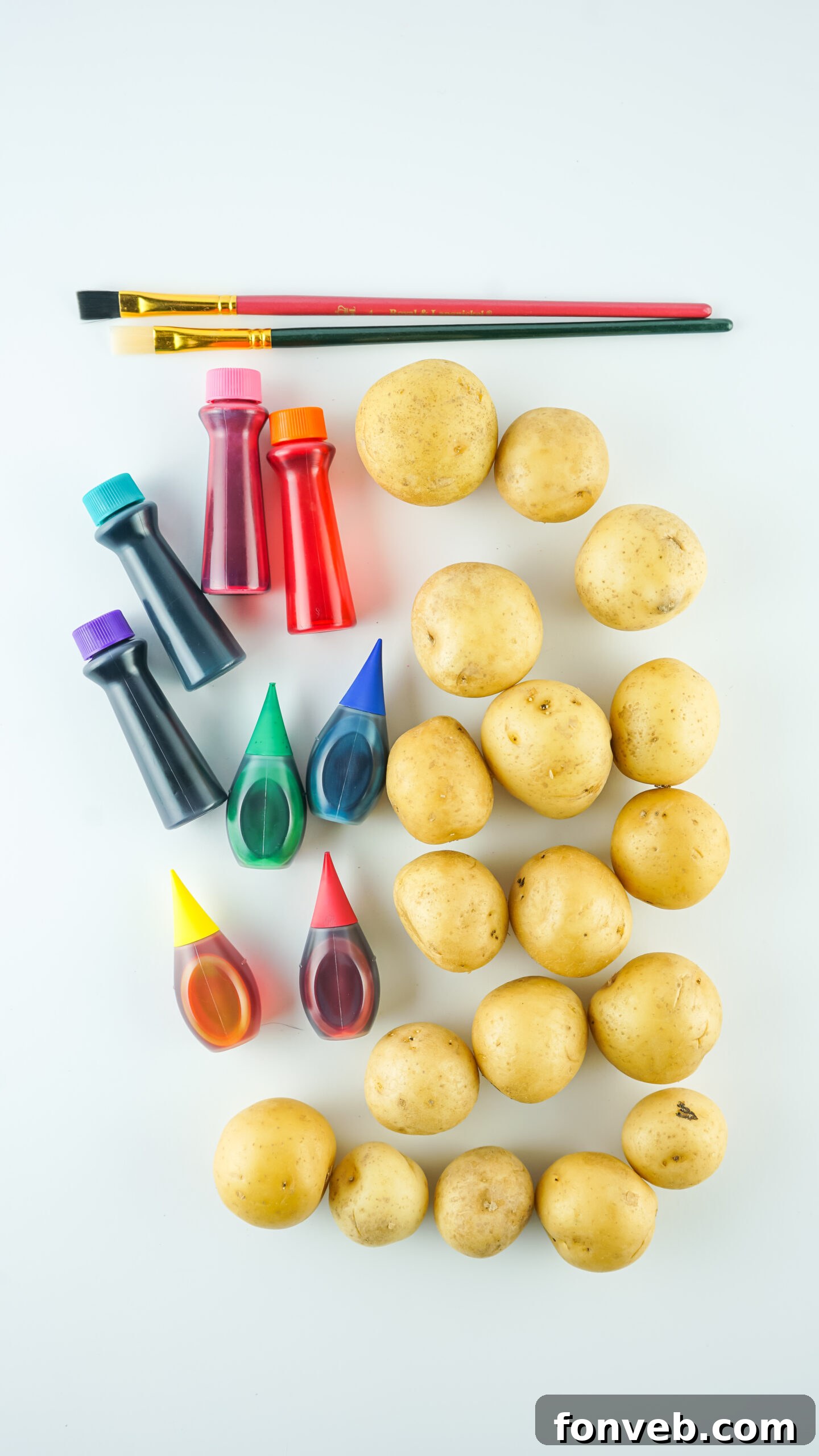 Overhead flat lay of all the materials and ingredients required to make the Dyed Easter Egg Potatoes craft.