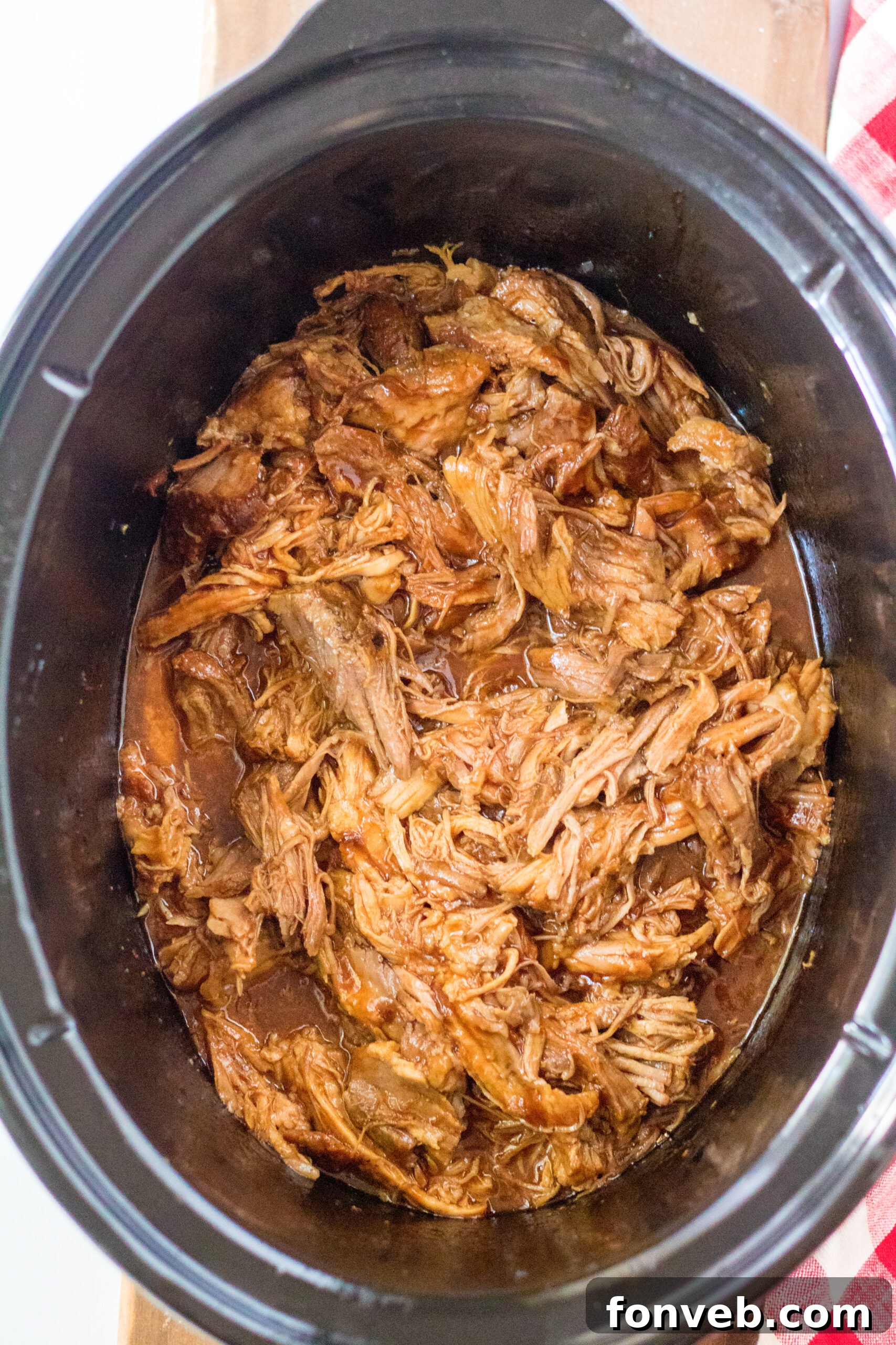 Sticky Sweet Slow Cooker Coke Pulled Pork 2 Overhead view of Slow Cooker Cola Pulled Pork in a crock pot.