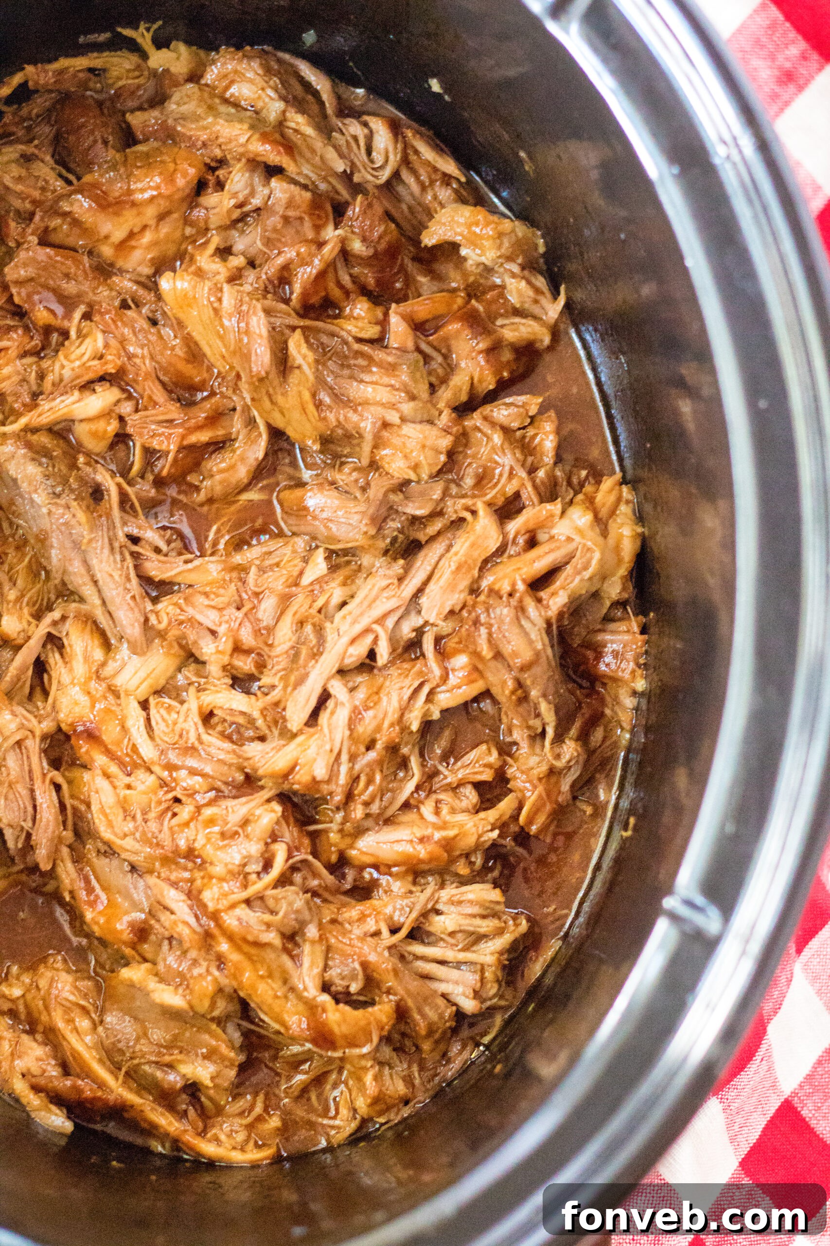 Sticky Sweet Slow Cooker Coke Pulled Pork 3 Close up view of Slow Cooker Cola Pulled Pork in a crock pot.