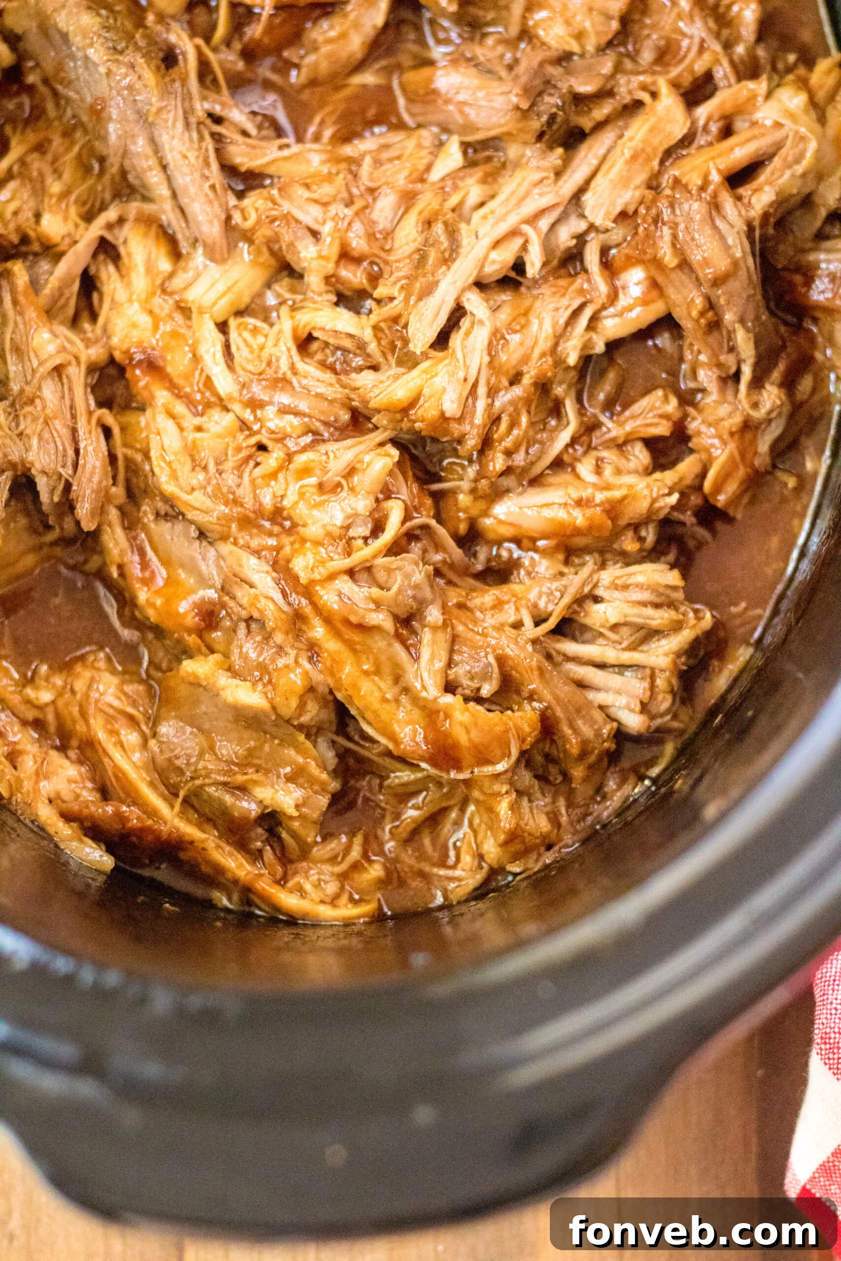 Sticky Sweet Slow Cooker Coke Pulled Pork 4 Close up view of Slow Cooker Cola Pulled Pork in a crock pot.