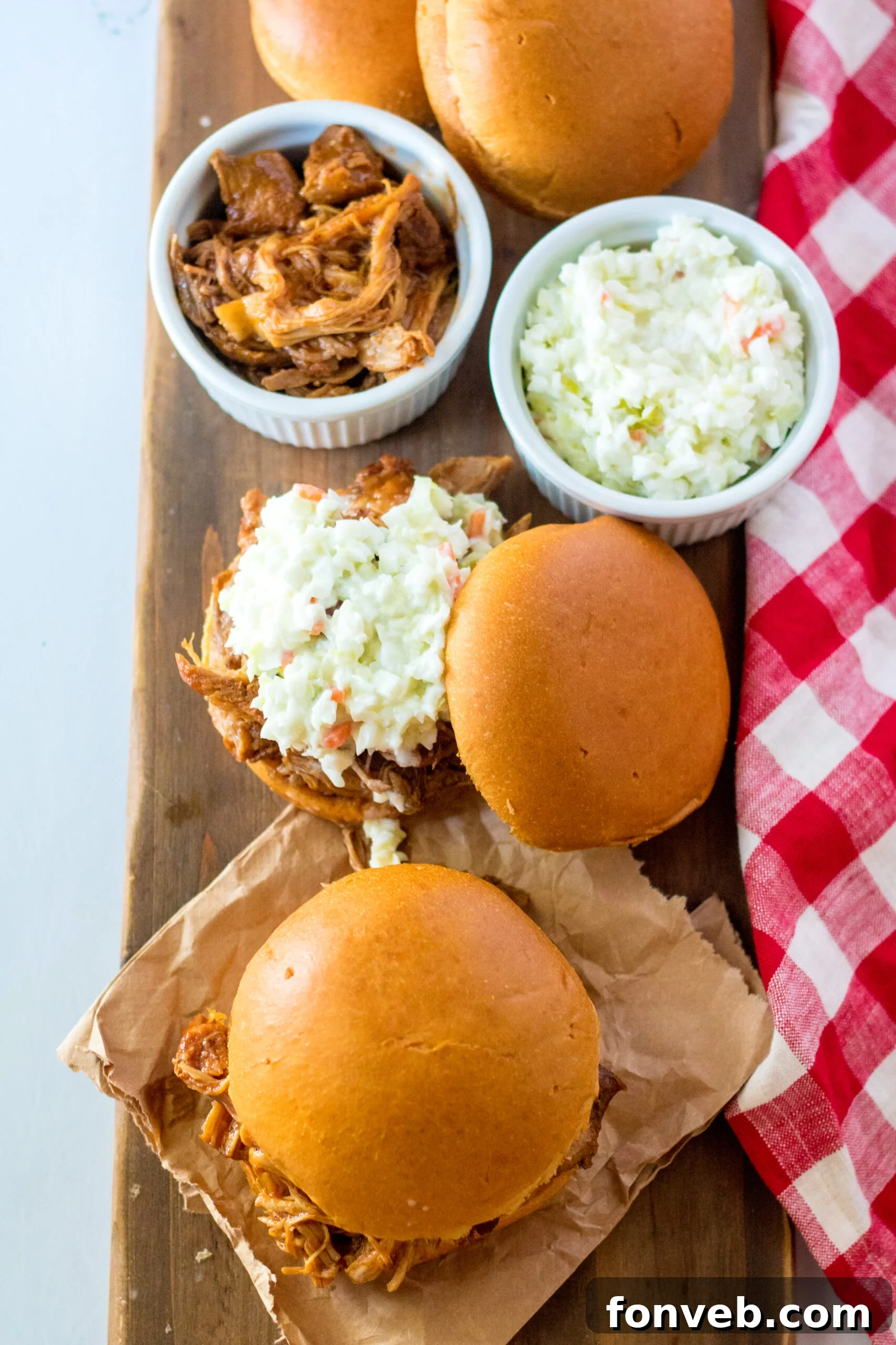 Sticky Sweet Slow Cooker Coke Pulled Pork 9 Overhead view of Slow Cooker Cola Pulled Pork on a bun served with coleslaw.