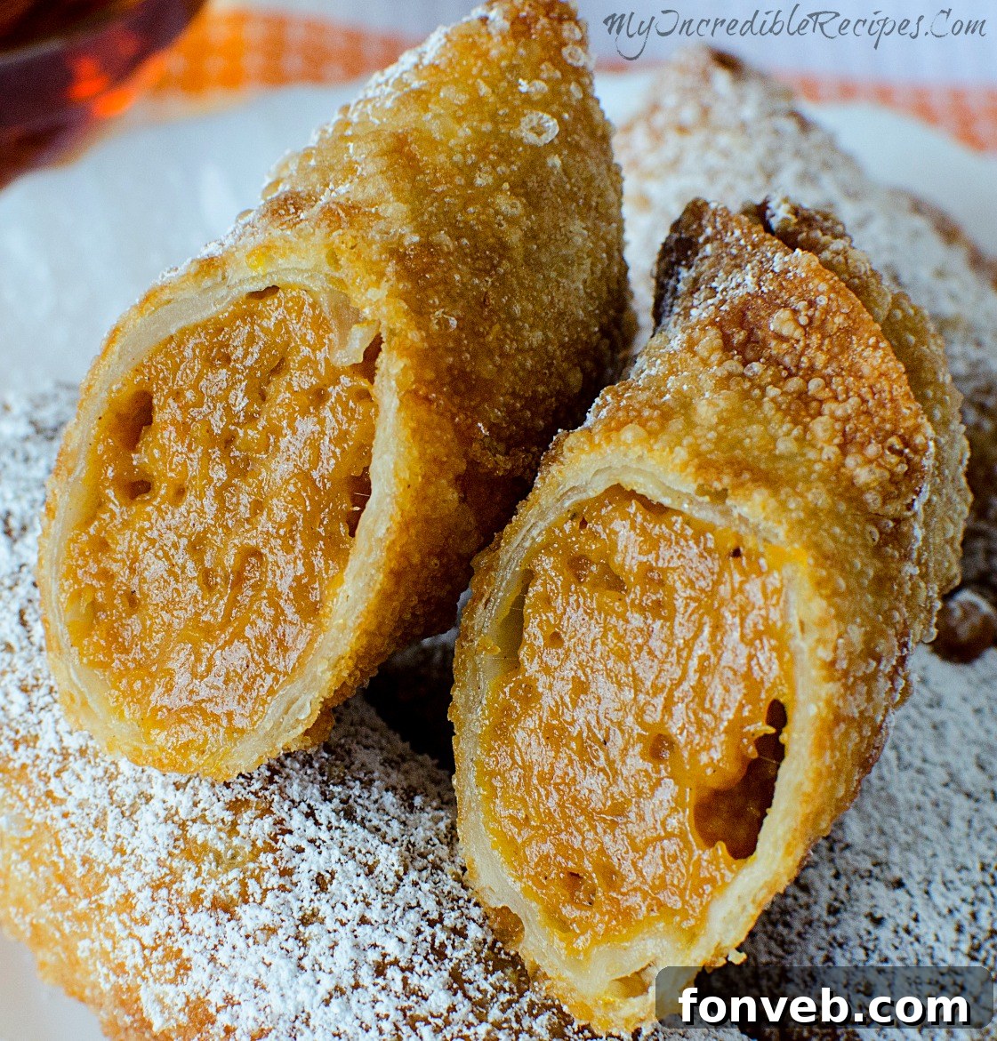 Delicious Pumpkin Pie Egg Rolls dusted with powdered sugar, ready to be enjoyed