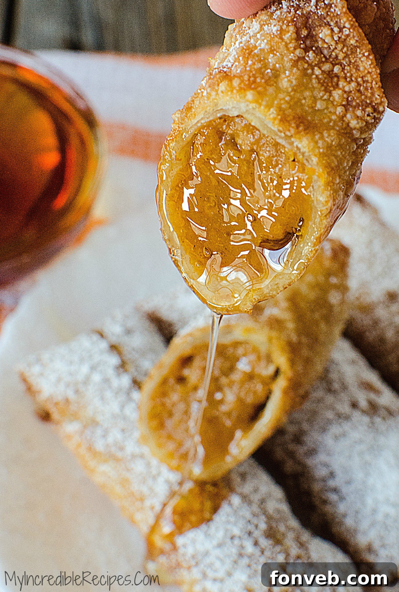 Garnished pumpkin pie egg rolls with powdered sugar, arranged for serving