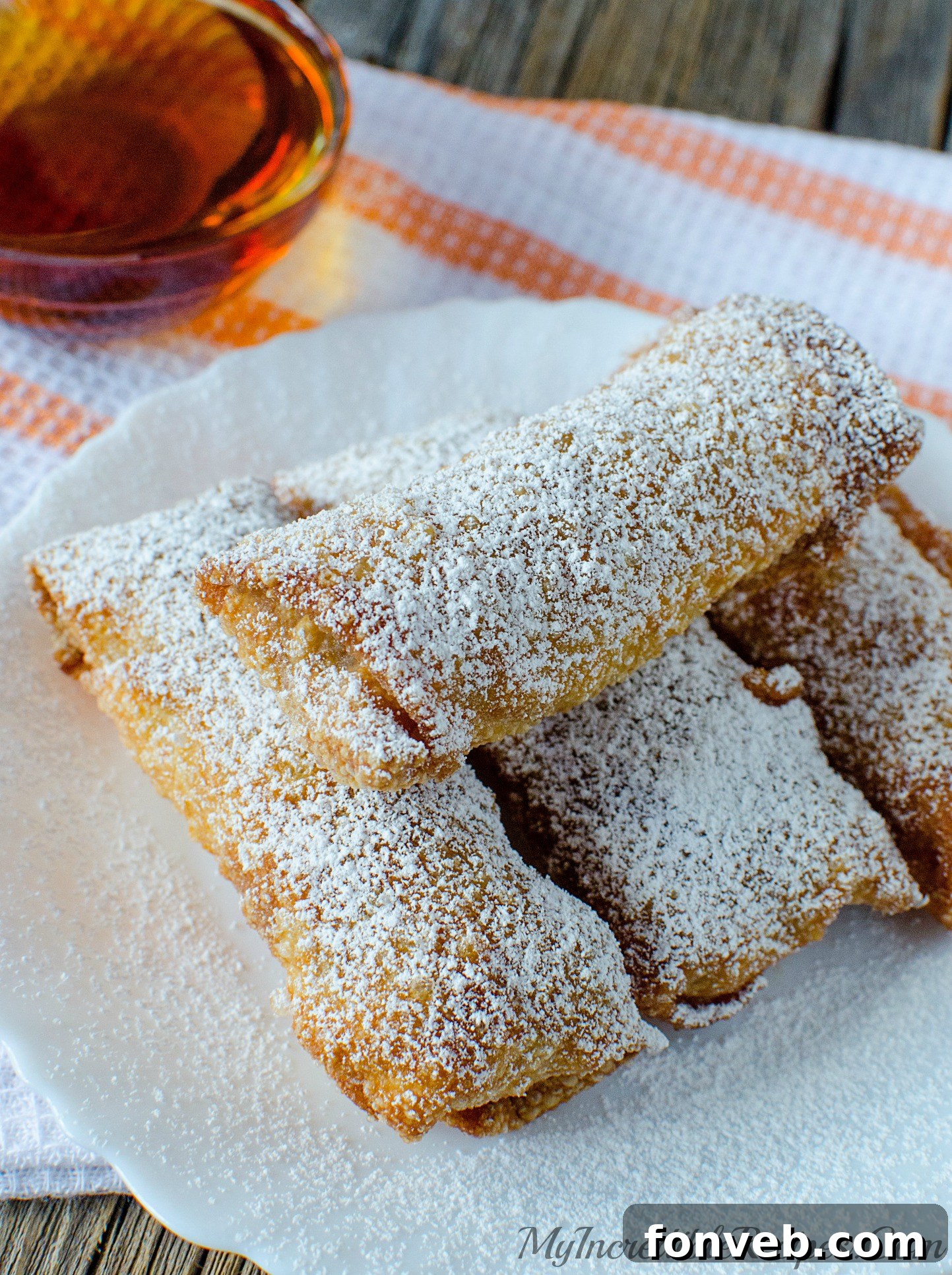 Uncooked pumpkin pie egg rolls neatly arranged, awaiting frying