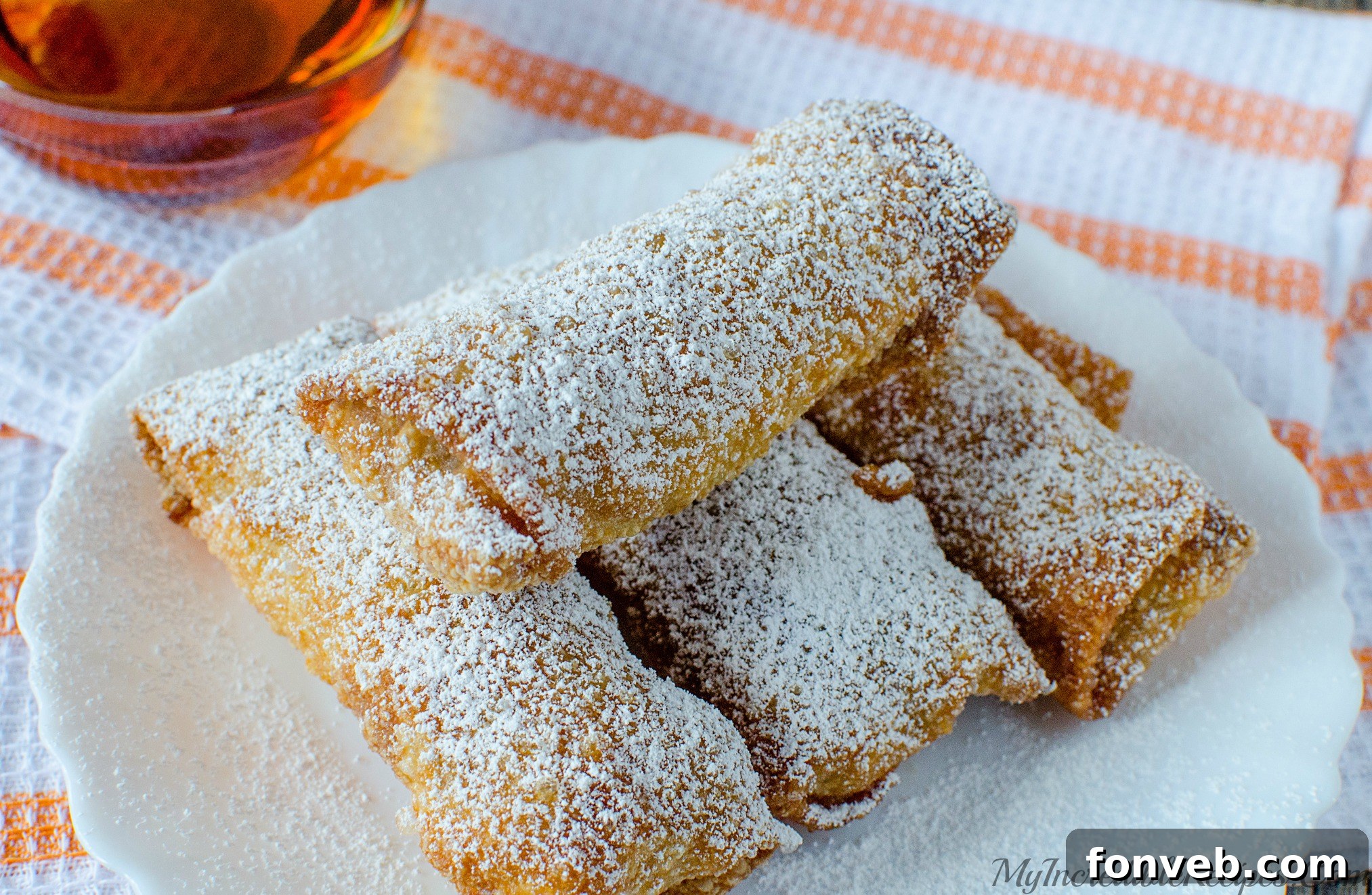 Close-up of egg roll wrappers being filled with spiced pumpkin puree