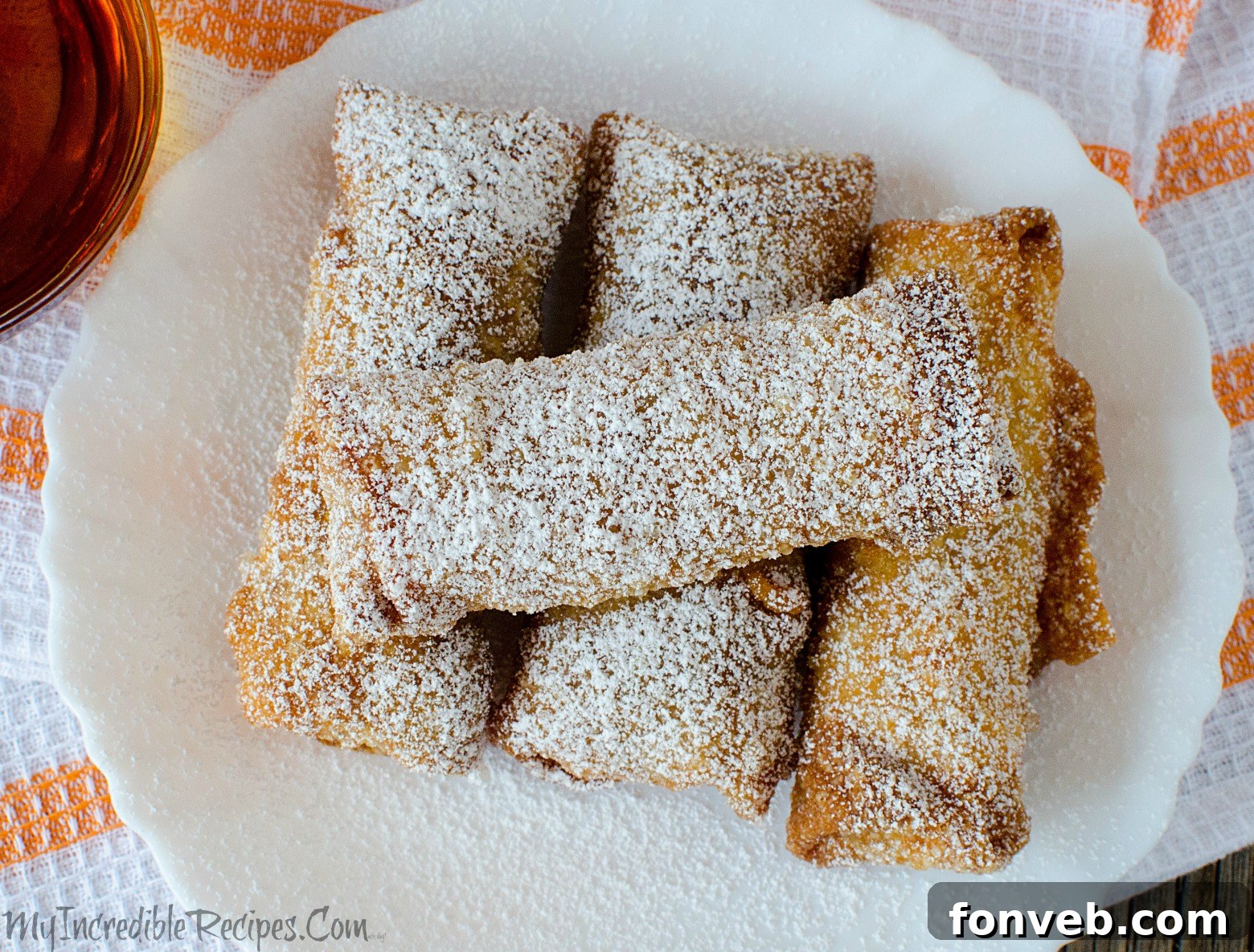 Assortment of pumpkin pie egg rolls on a platter, ready for guests